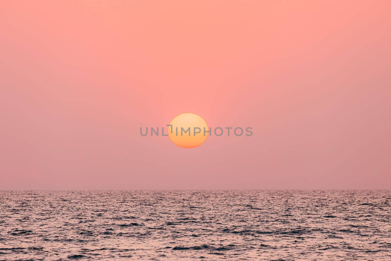 Natural Color Sunset Sunrise Sky Over Sea. Seascape With Shining Setting Sun On Sea Horizon.