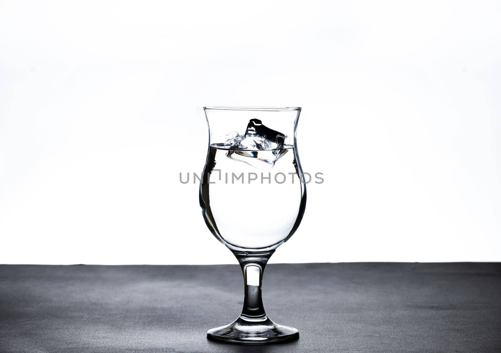 The image of pouring drinking water, into a glass, that makes one feel refreshed on blurred white background, Splashing water, Sparkling water