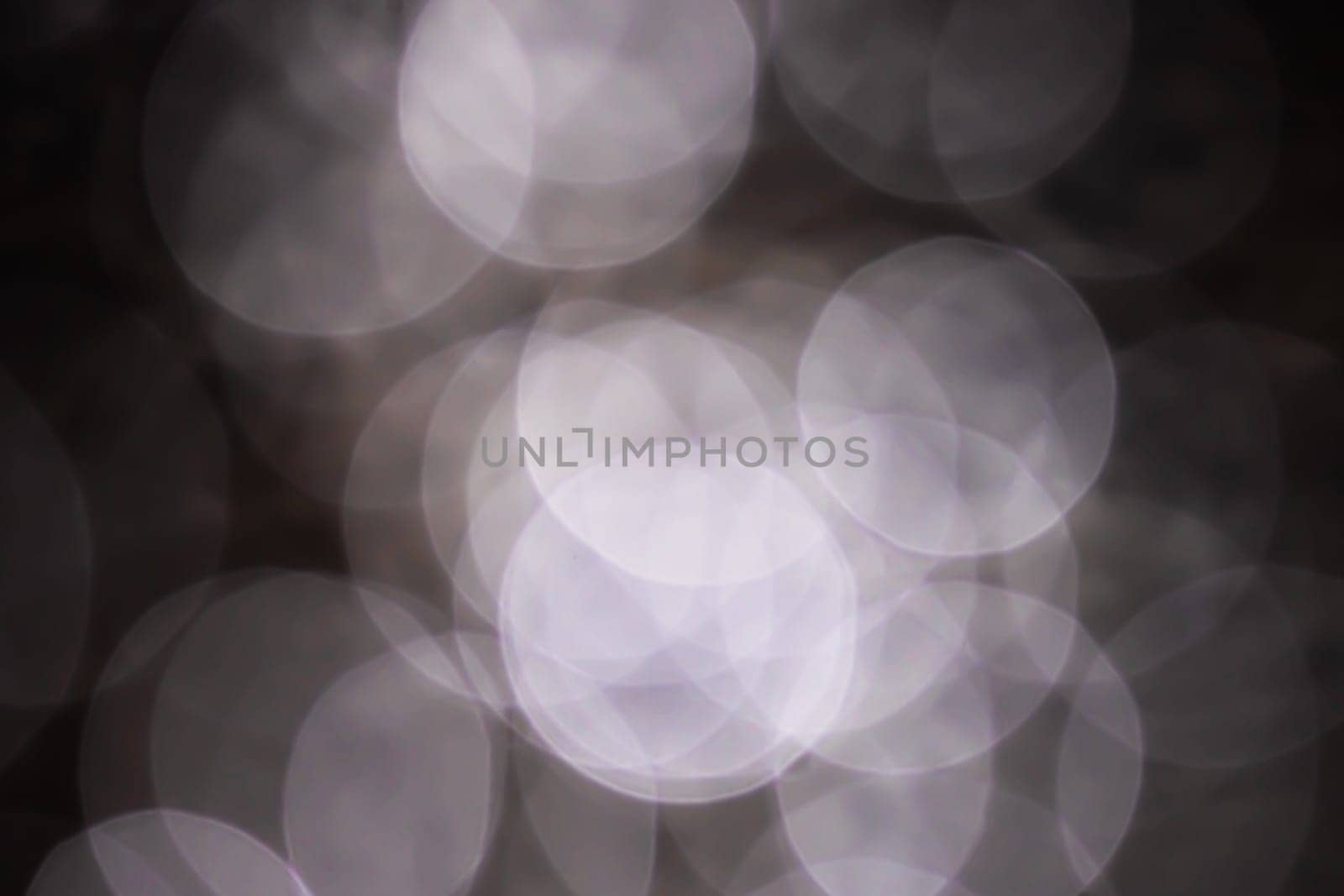 Light abstract dark bokeh christmas circle color glitter blurred black background