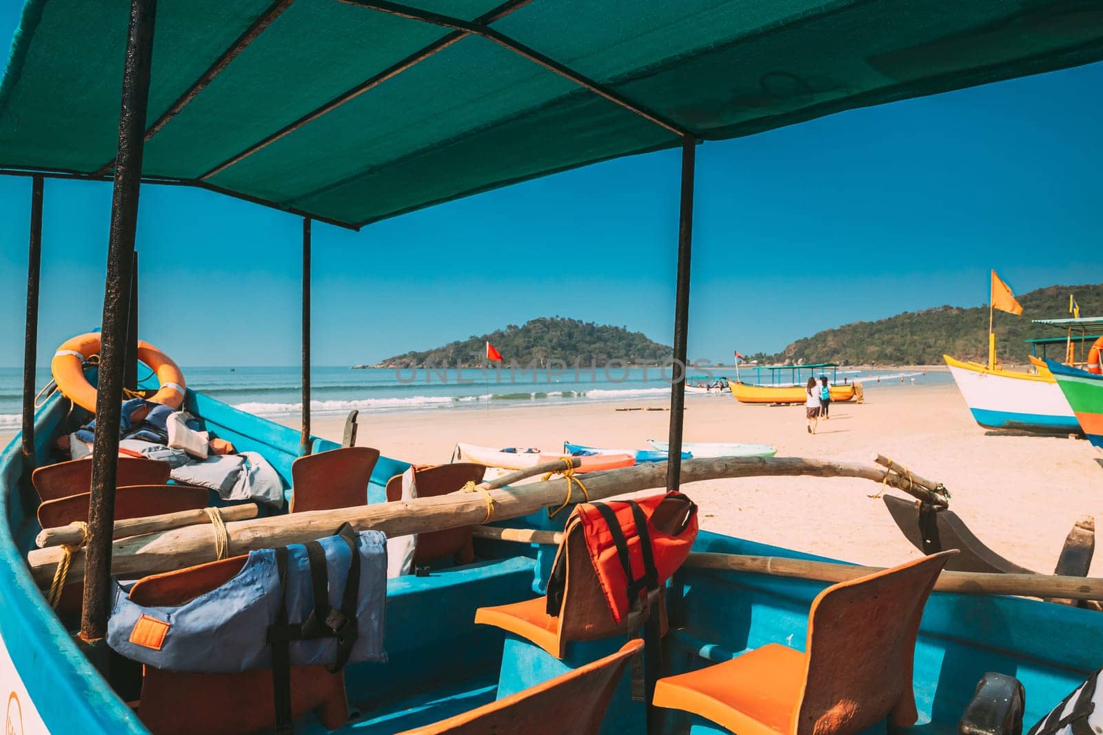 Canacona, Goa, India. Sightseeing Tourist Boat Parked On Famous Palolem Beach In Summer Sunny Day.