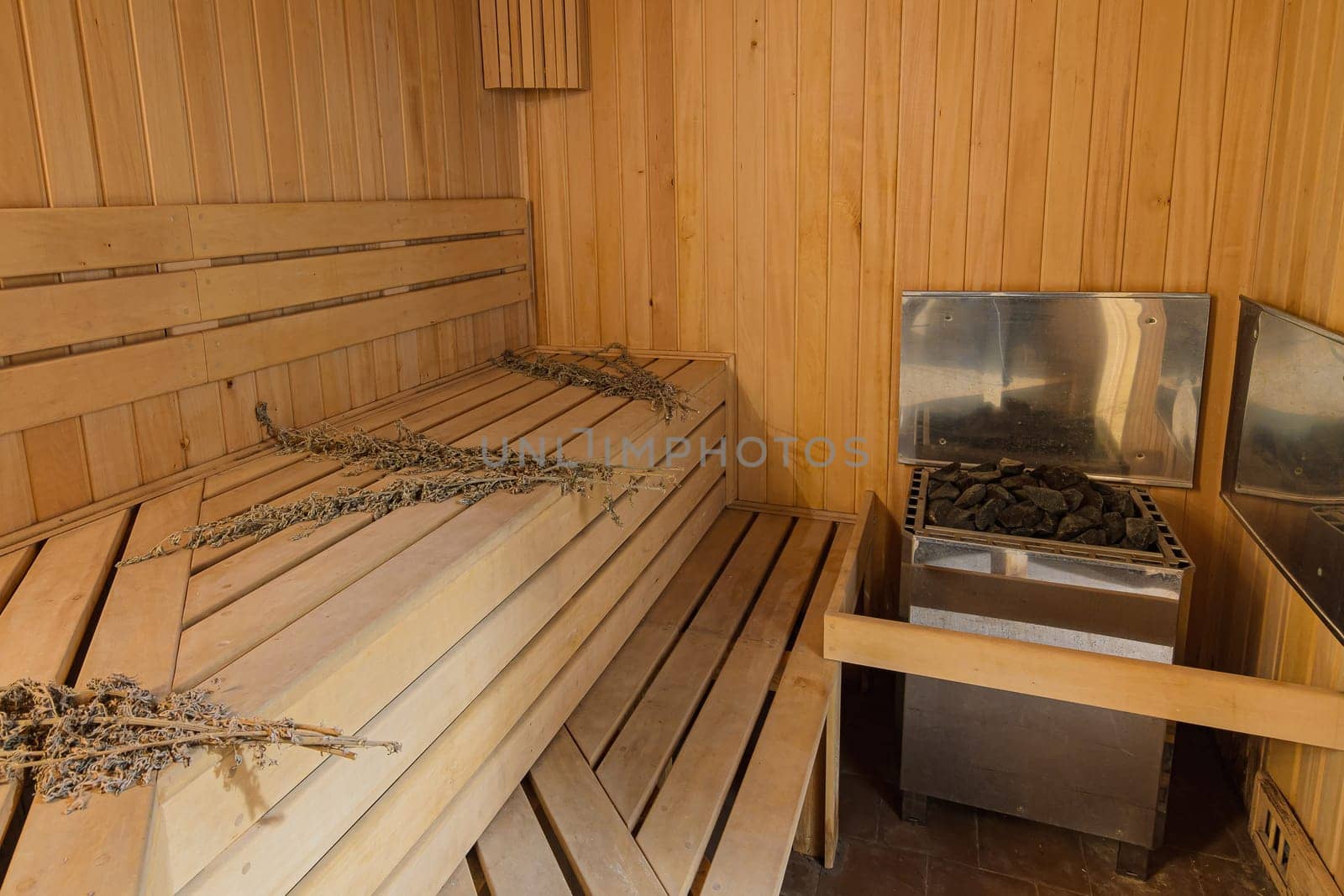 Interior of a sauna in a private house with an electric boiler