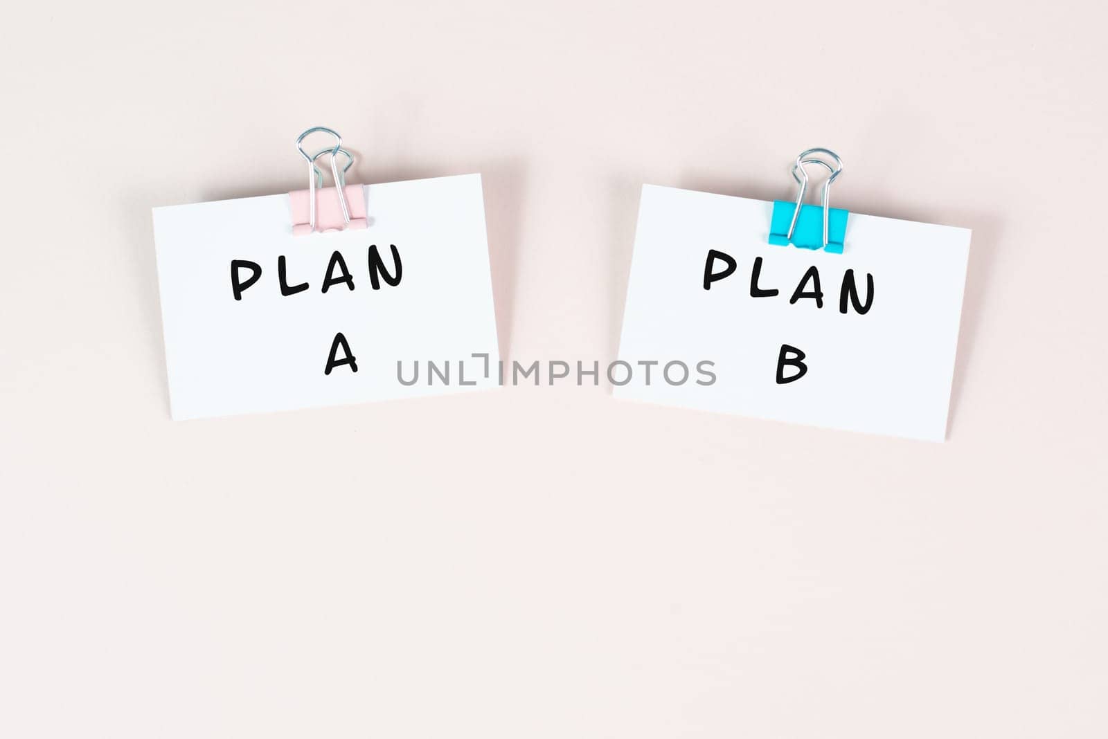 Plan A and B standing on paper, brainstorming for possibilities, making a decision