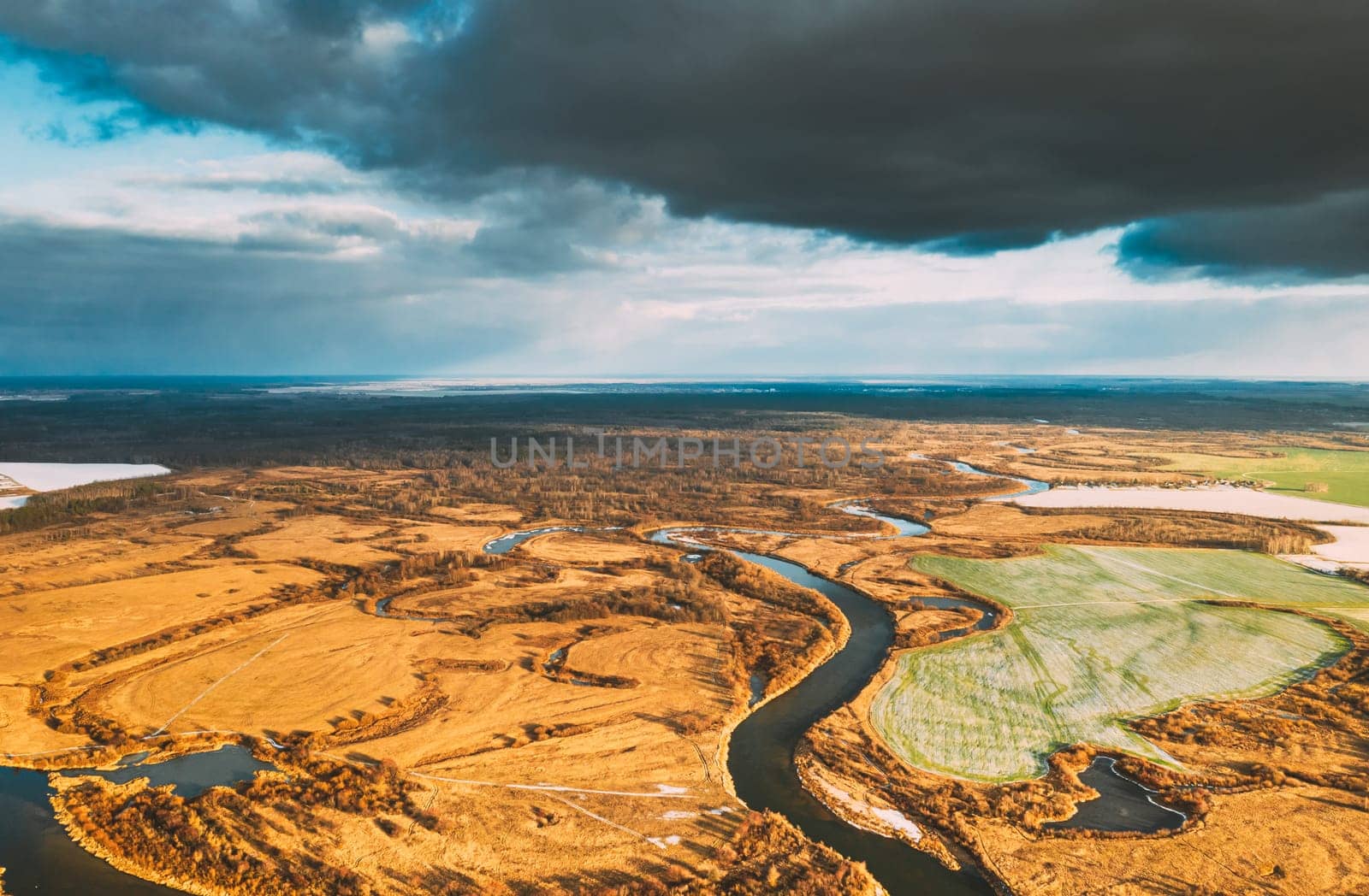 Europe. Aerial View Of Dry Grass And Partly Frozen Curved River Landscape In Autumn Day. High Attitude View. Marsh Bog. Drone View. Bird's Eye View.