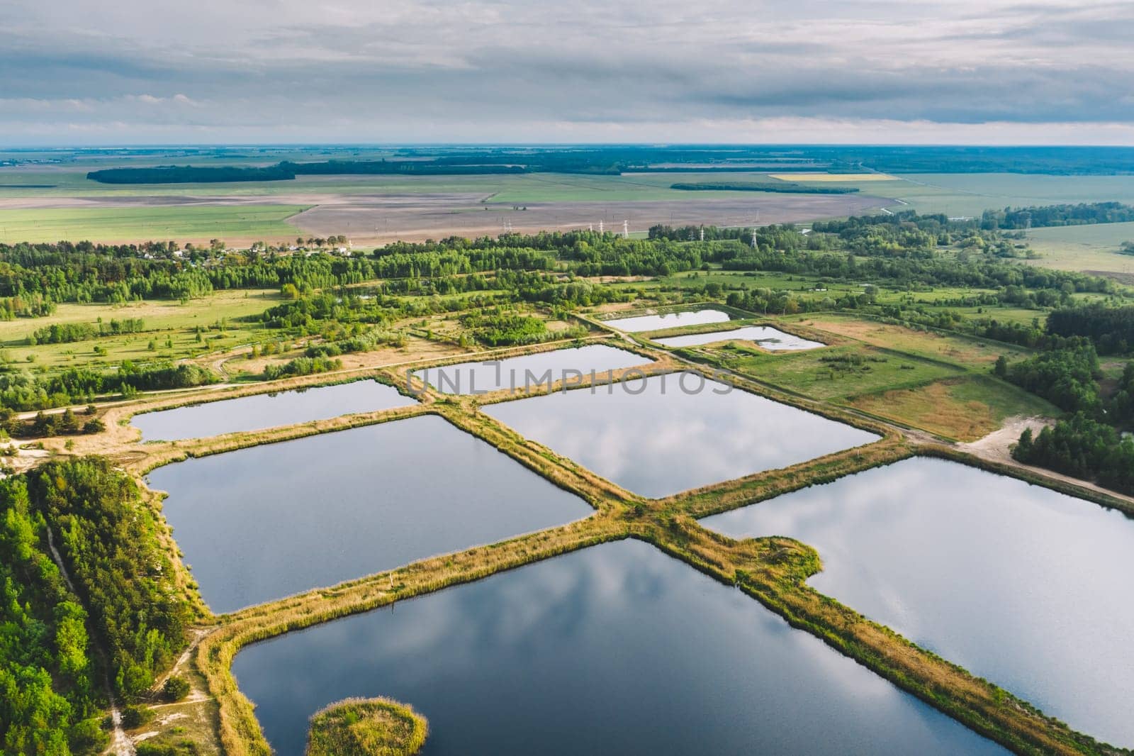 Aerial View Retention Basins, Wet Pond, Wet Detention Basin Or Stormwater Management Pond, Is An Artificial Pond With Vegetation Around The Perimeter, And Includes A Permanent Pool Of Water In Its Design.