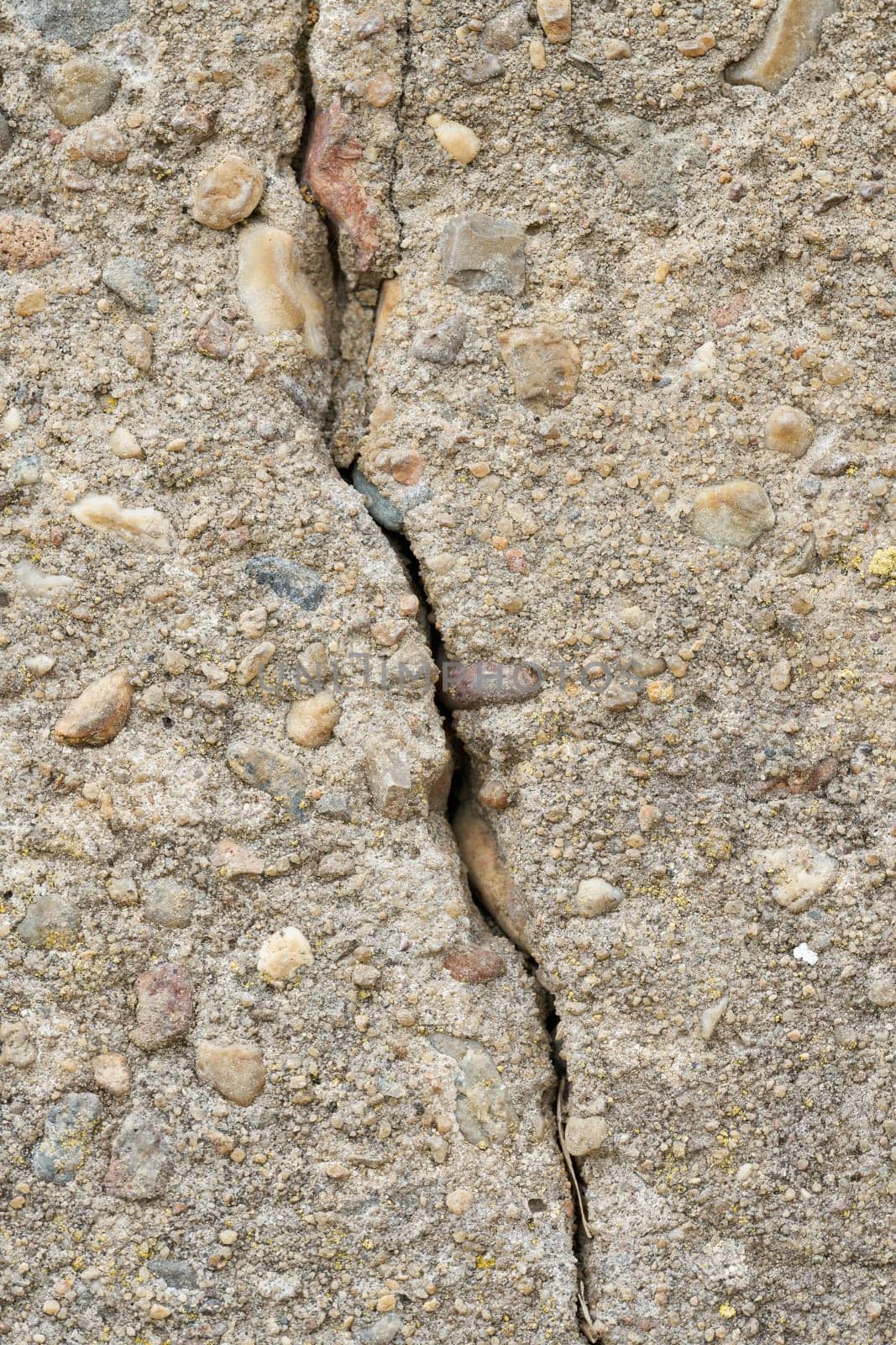 Close up of cracks in a dilapidated concrete wall on a building