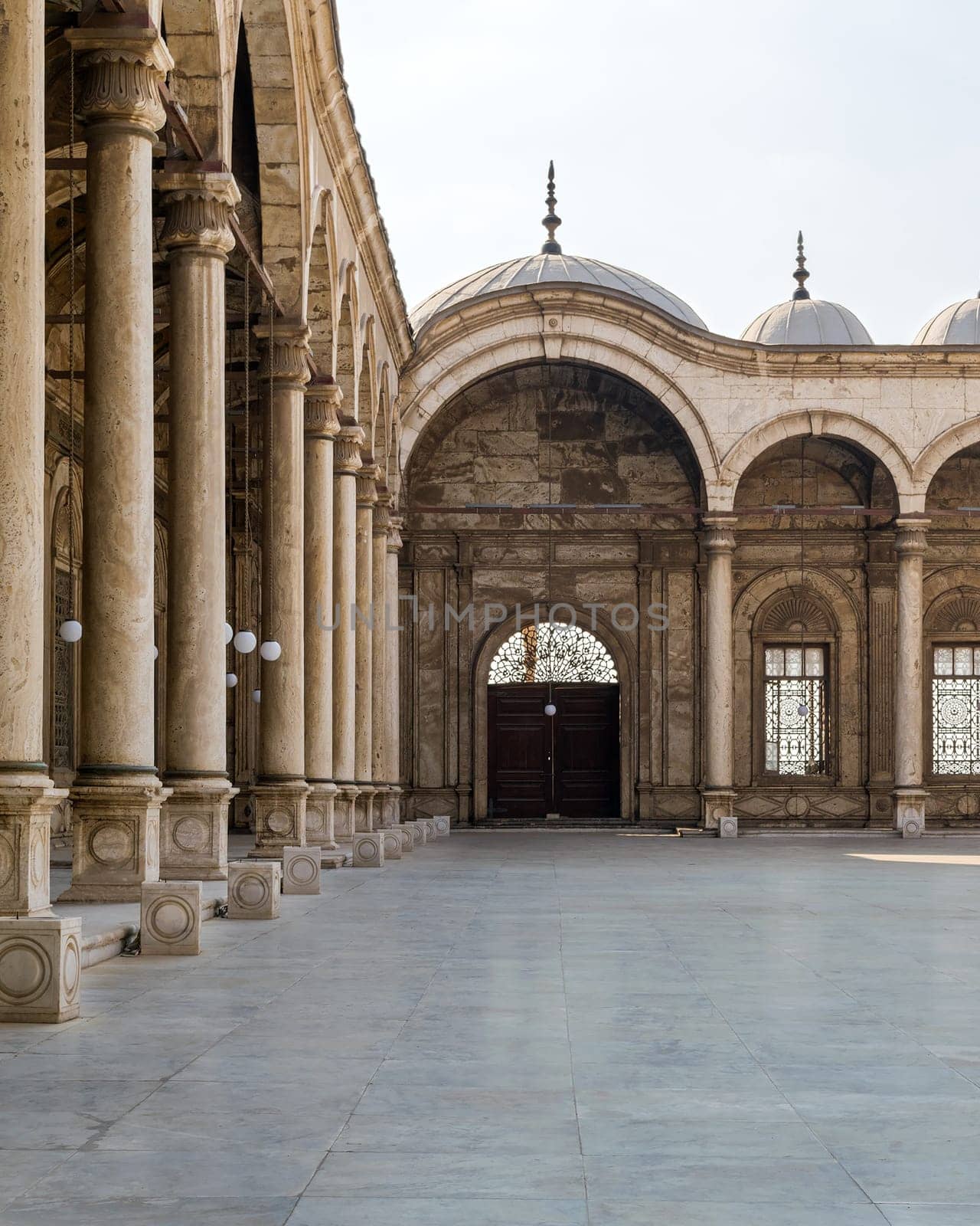 Passage surrounding the court of the Great Mosque of Muhammad Ali - Alabaster Mosque - with wrought iron decorated windows and wooden door, alabaster wall, arches and domes, Cairo Citadel, Egypt