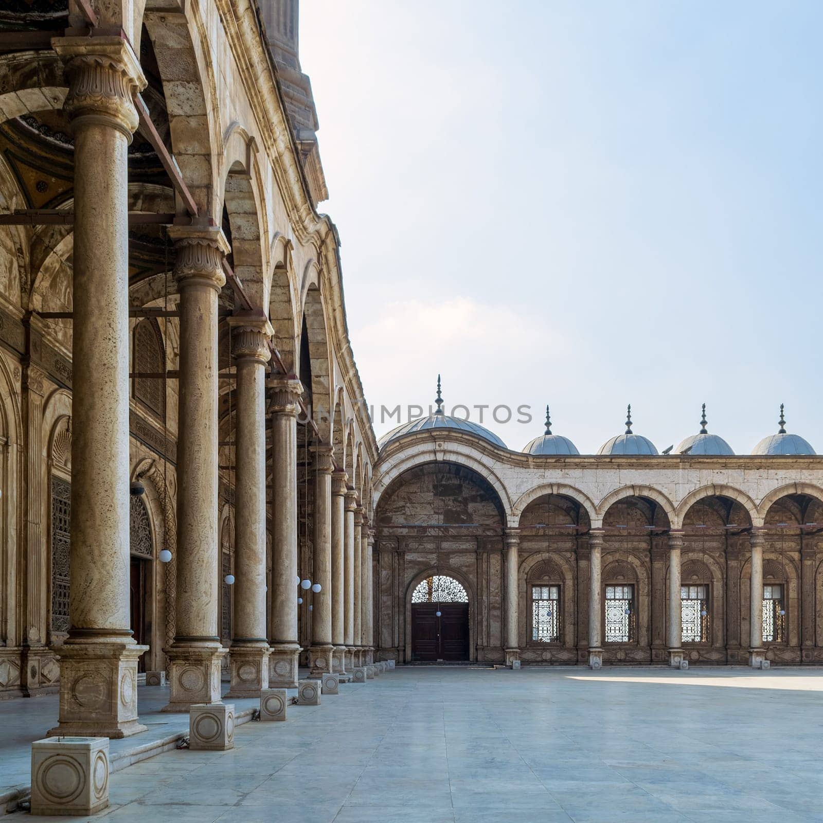 Passage surrounding the court of the Great Mosque of Muhammad Ali - Alabaster Mosque - with wrought iron decorated windows and wooden door, alabaster wall, arches and domes, Cairo Citadel, Egypt