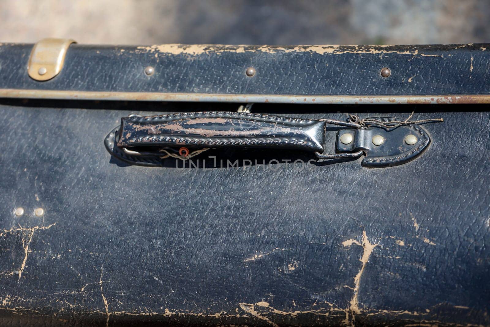 A close-up, detail shot of an old leather suitcase.