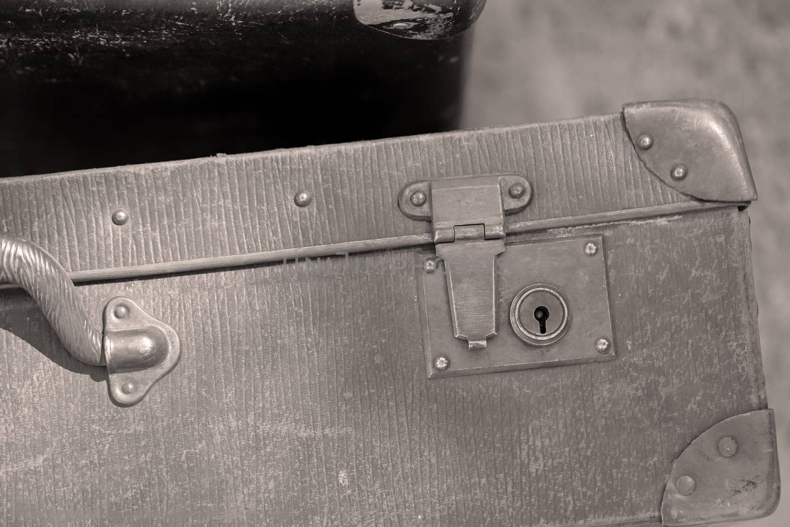 A close-up, detail shot of an old leather suitcase.