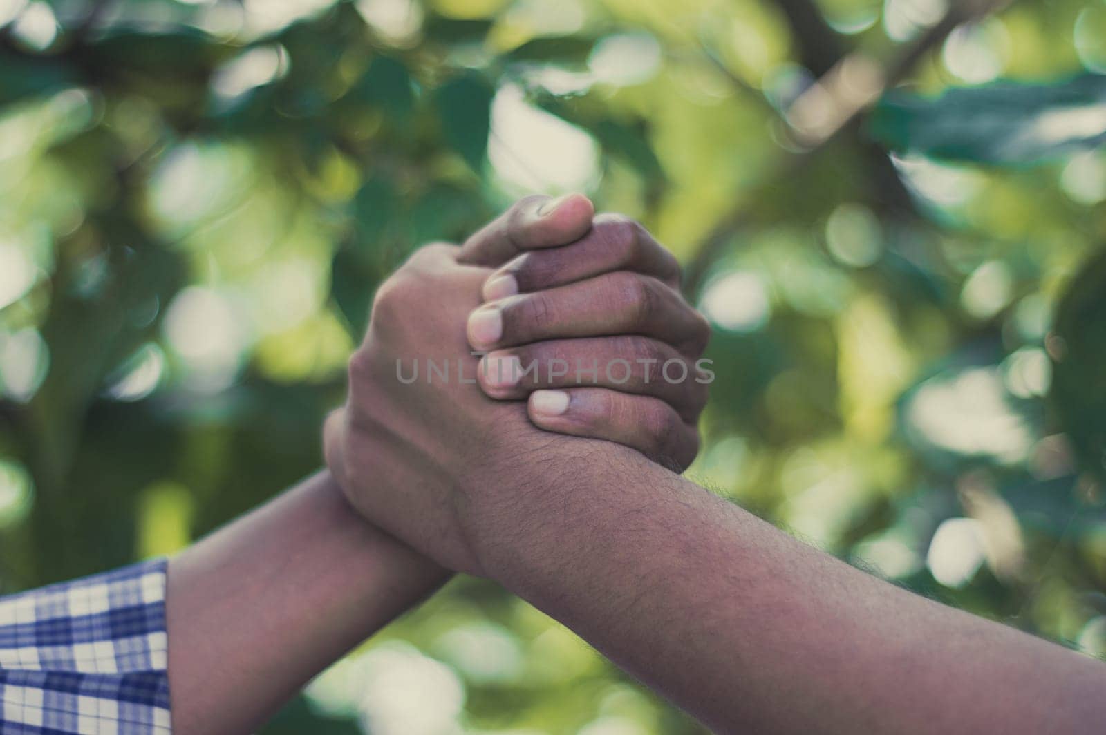Friends Shaking Hands. Handshake man. Friendly handshake of two men. Close up of men greeting with handshake. Friends handshaking of two hands.