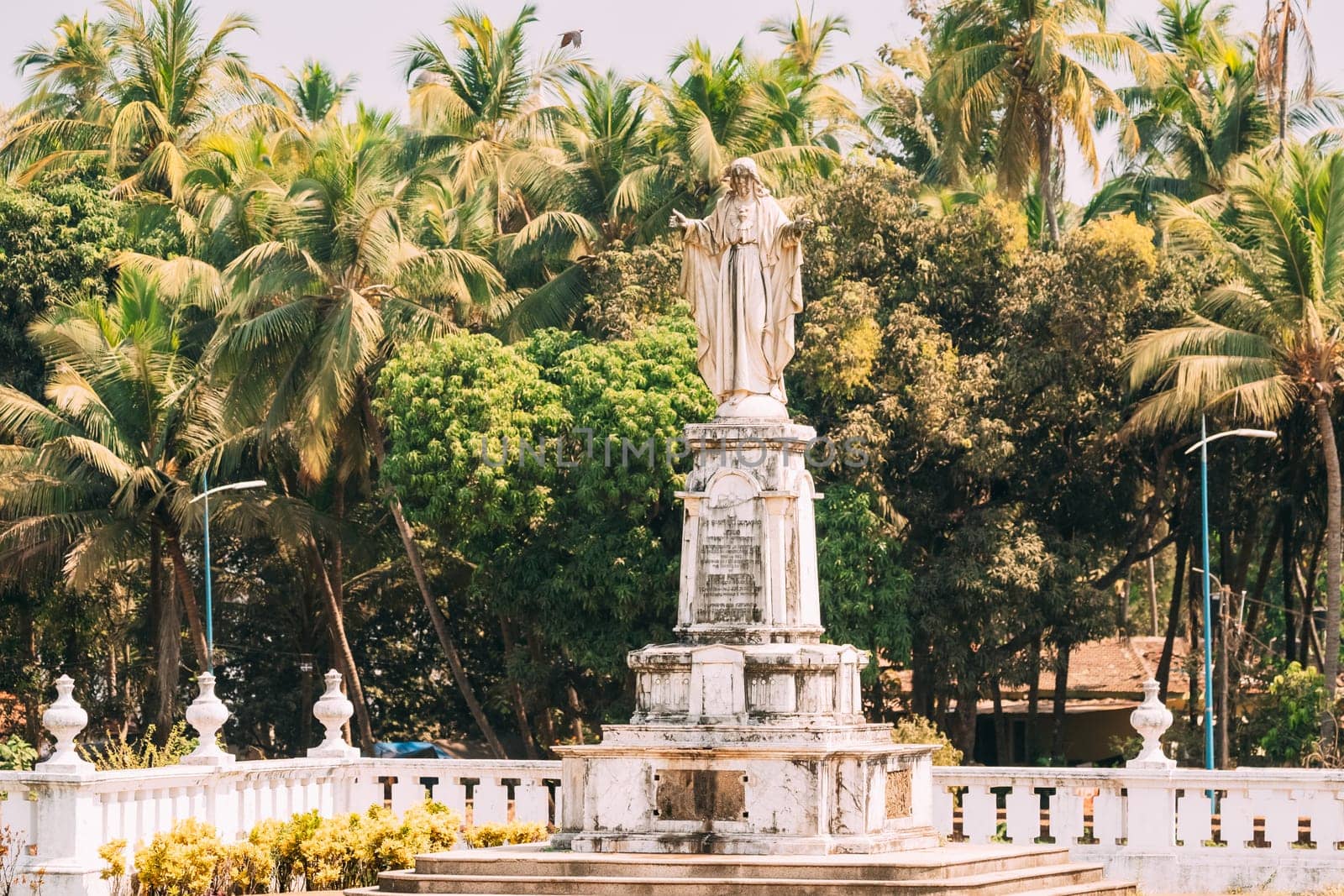 Old Goa, India. Cathedral Of St. Paul And Statue Of Jesus In Sunny Day.