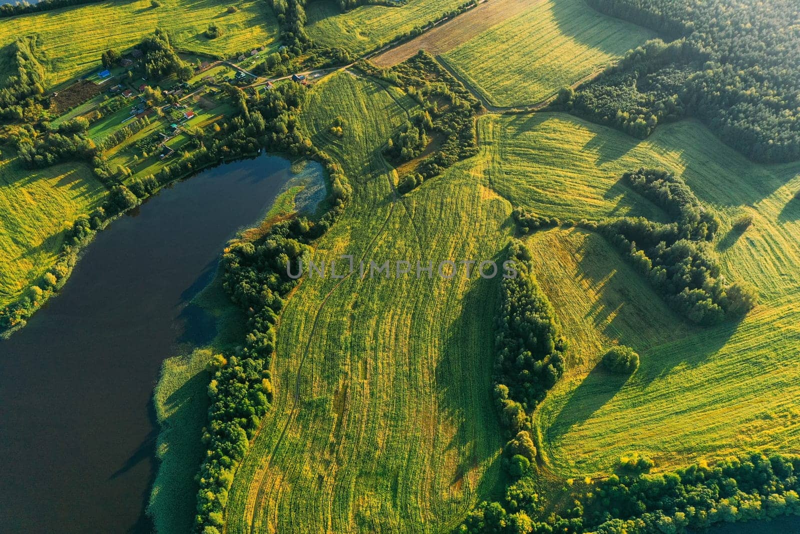 Lyepyel District, Vitebsk Region, Belarus. Aerial View Of Residential Area With Houses In Countryside. Sunny Autumn Morning. Sun Shining Above Town Skyline And Lepel Lake. Flat View.
