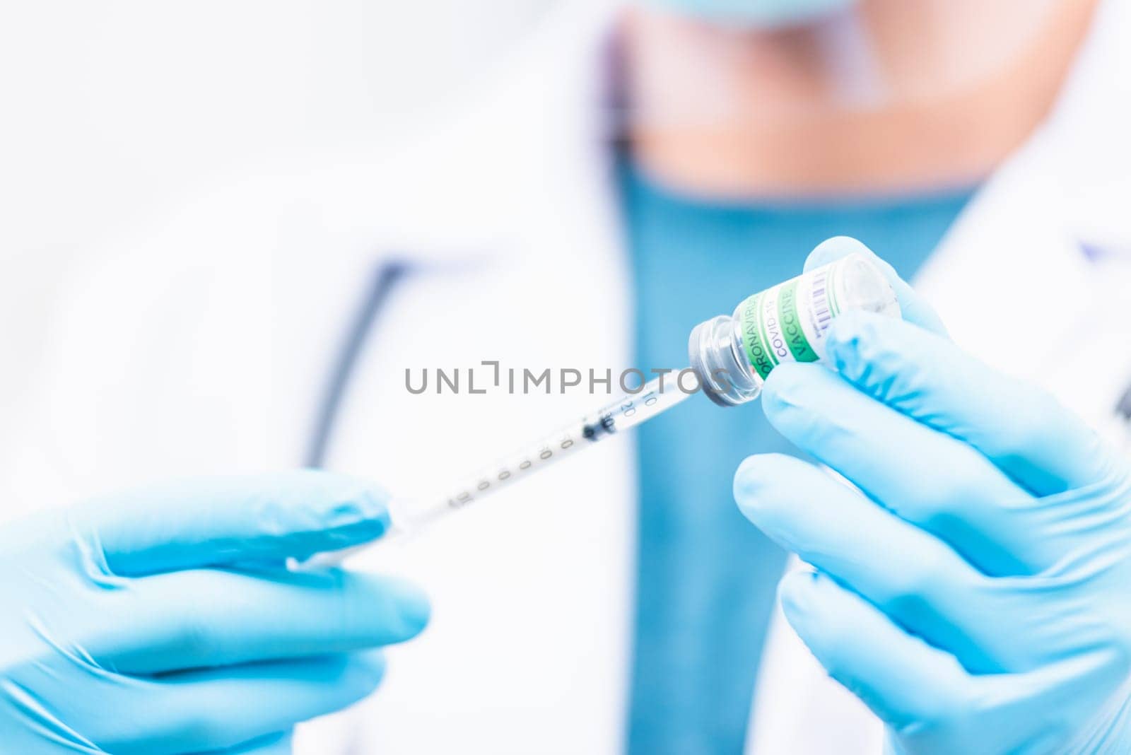 COVID-19 vaccine, Doctor man pull syringe on liquid bottle COVID-19 (coronavirus) vaccine for injection at hospital, nurse holding medicine and drug concept