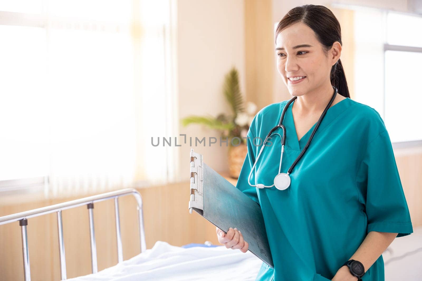 Portrait of a smiling nurse or medical staff in a hospital, happy woman doctor in uniform holding clipboard, people medical healthcare concept