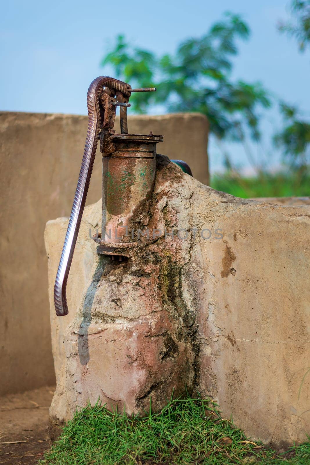 Local rusted traditional old hand operated water pump in a storage basin at an Egyptian rural village