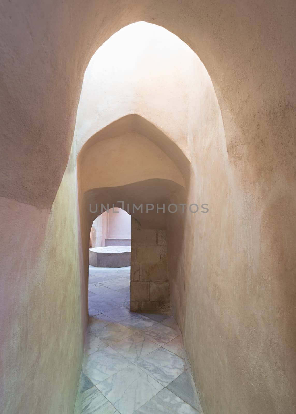 Aged narrow dark stone vaulted passage at ottoman era public Turkish historical traditional Hamam Inal bathhouse, Moez Street, Cairo, Egypt
