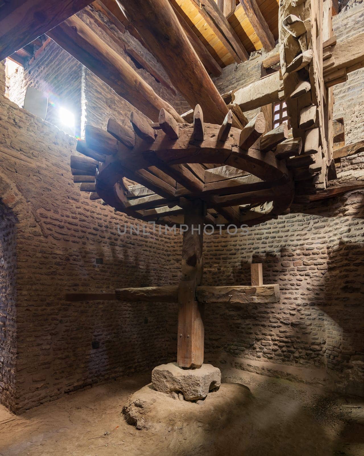 Aged water mill turning inside weathered mill building at Amir Taz palace, Medieval Cairo, Egypt