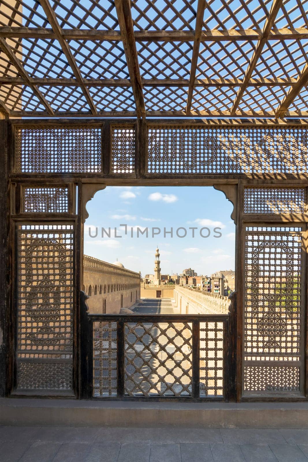 Passage surrounding the Mosque of Ibn Tulun framed by interleaved wooden perforated wall - Mashrabiya - Medieval Cairo, Egypt