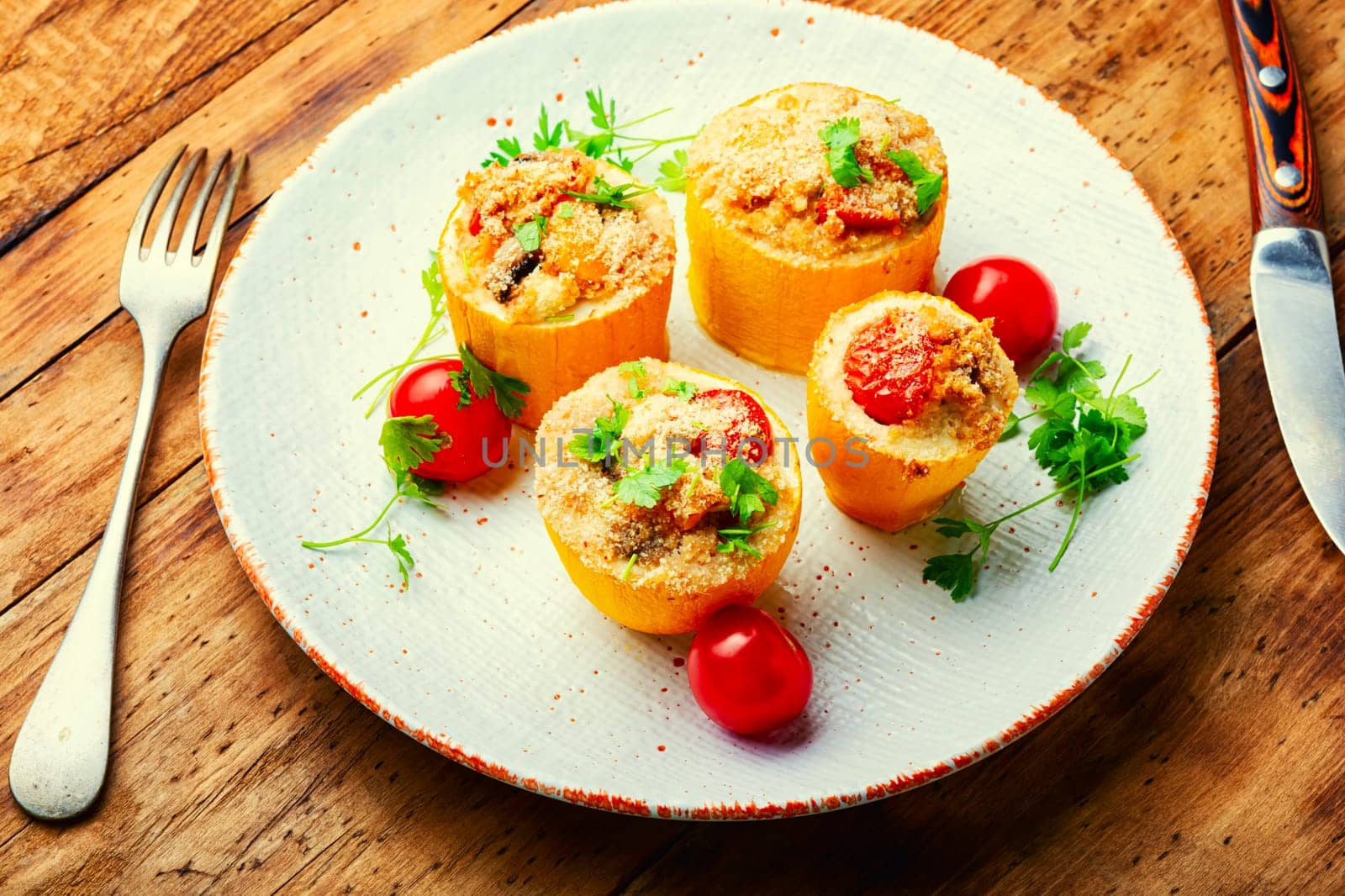 Baked zucchini stuffed with quinoa and vegetables. Vegetarian food