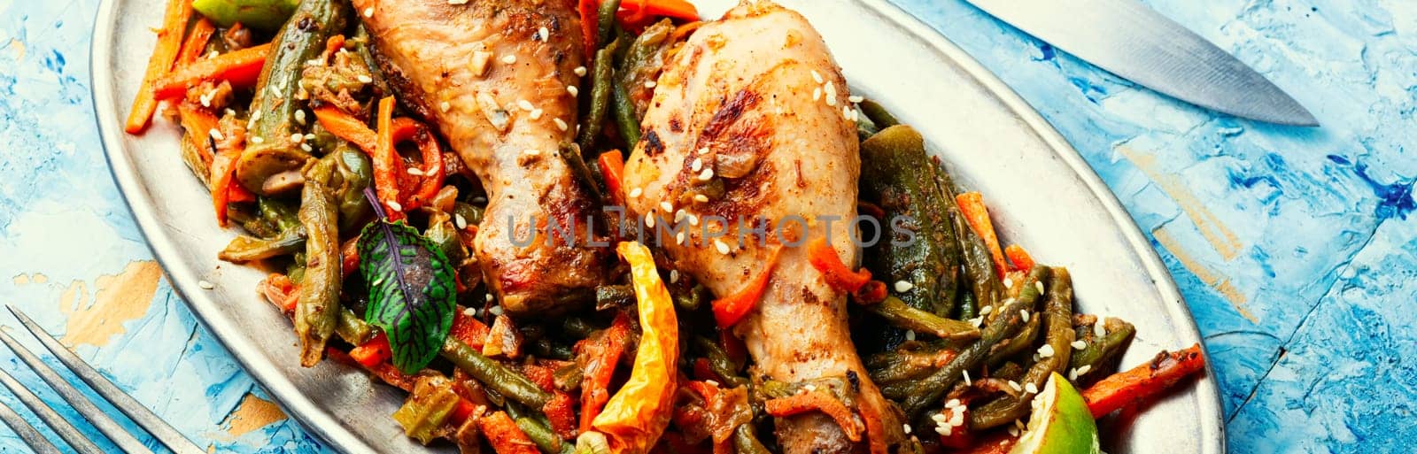 Roasted chicken with vegetable garnish and spices. Braised spicy chicken legs.