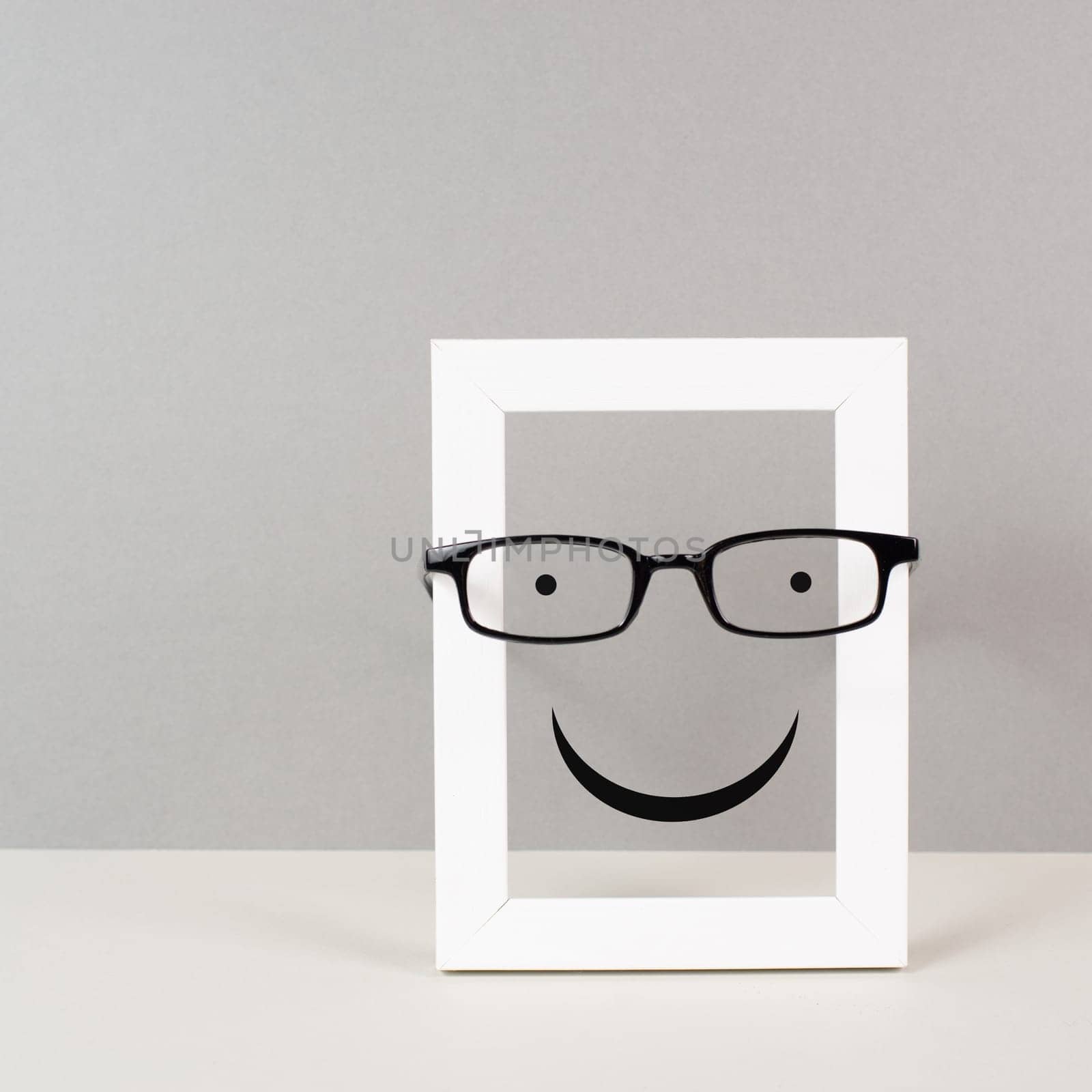 Frame with a happy face with eyeglasses, mental health concept, positive mindset and emotion, support and evaluation symbol