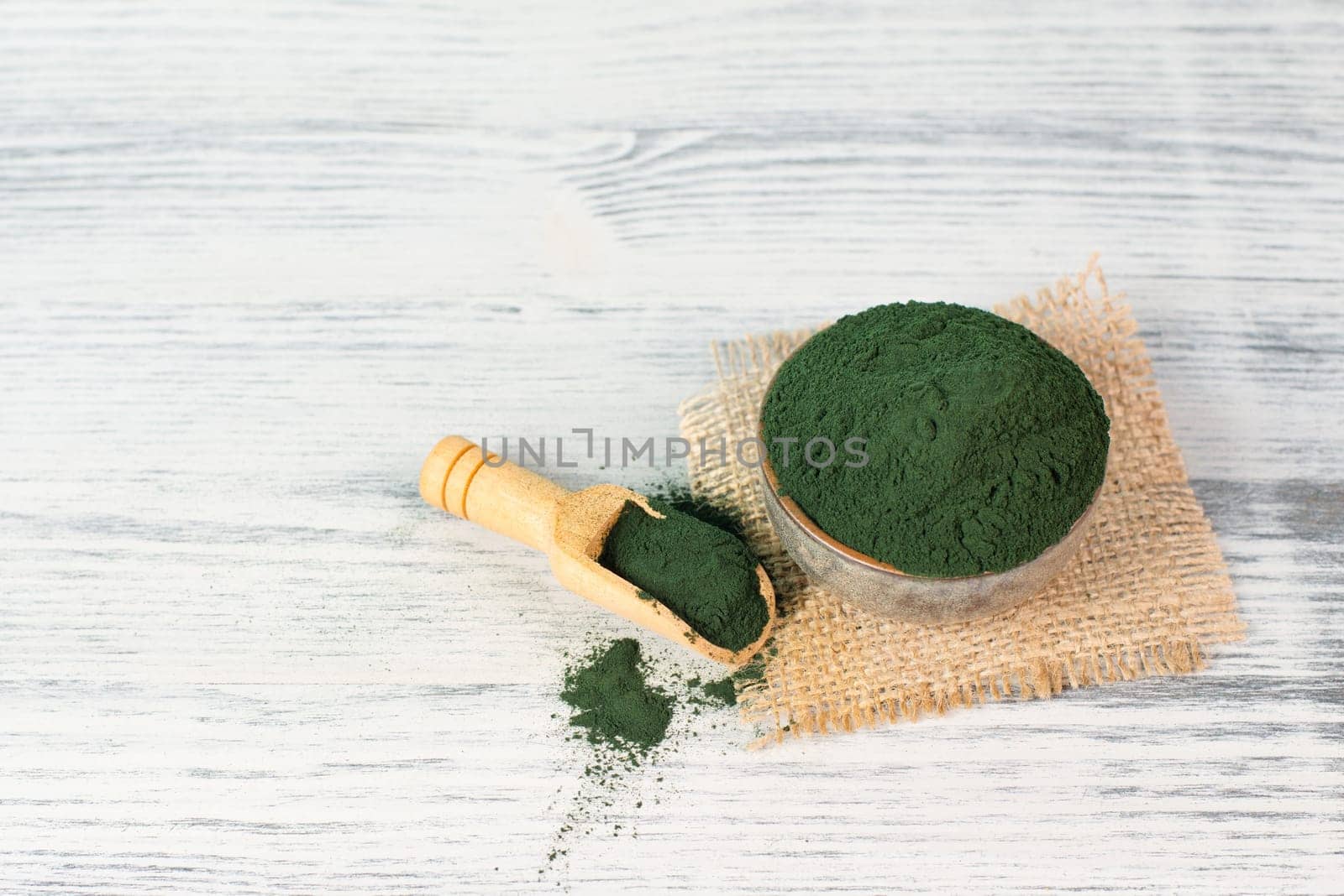 Spirulina algae powder in a bowl, alternative medicine for to detox, antioxidant food ingredients