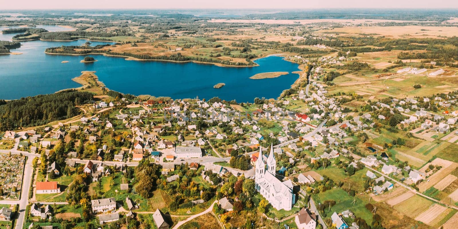 Slobodka, Braslaw District, Vitebsk Voblast, Belarus. Aerial View Of Potsekh Lake Near Slobodka Village. Church of Divine Providence. Panorama.