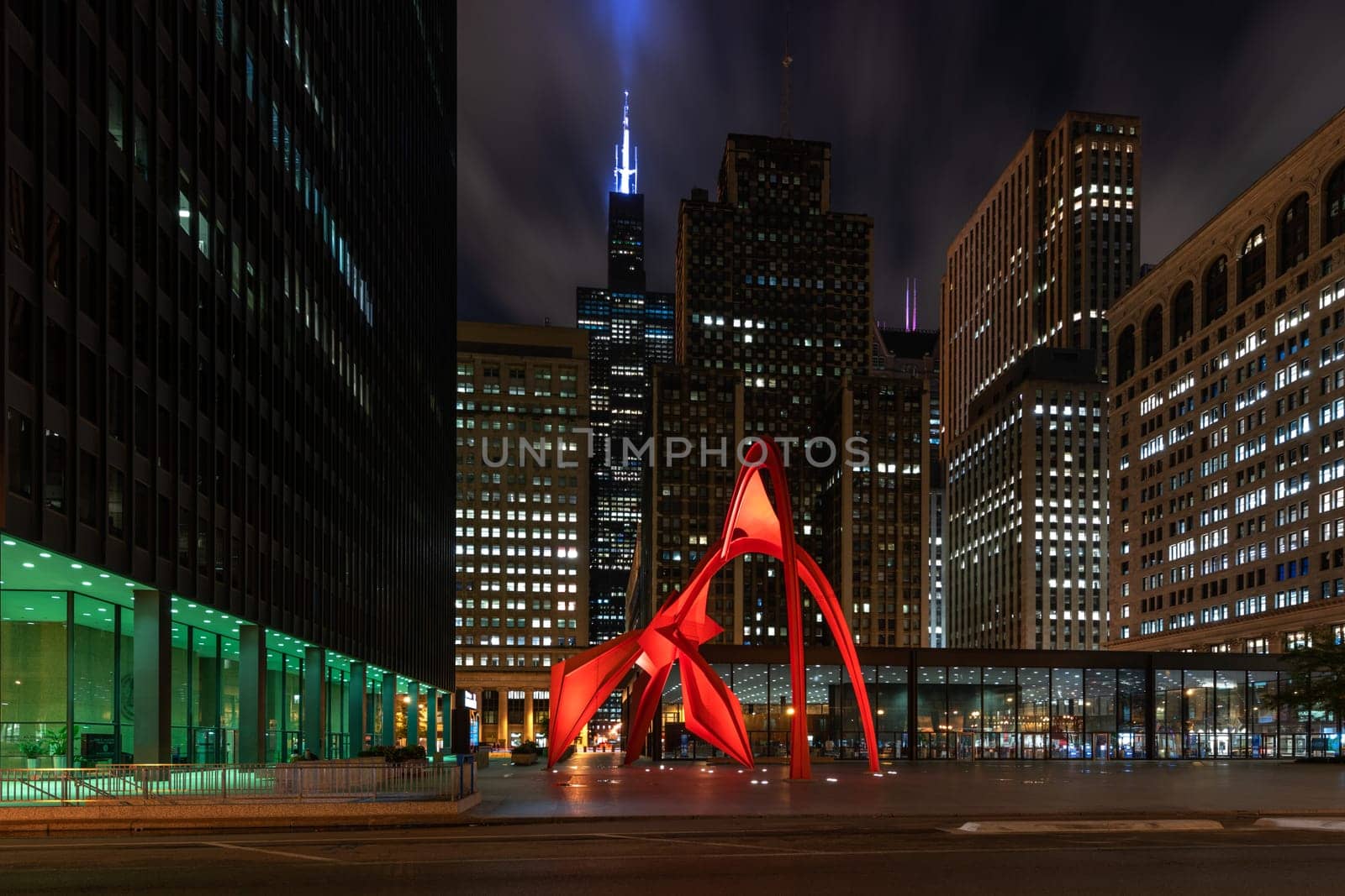 Chicago, Illinois / USA : October 13, 2018 Calder's Flamingo sculpture in the middle of the vibrant public place, Federal Plaza, in Chicago, enclosed by high-rise office buildings - Image