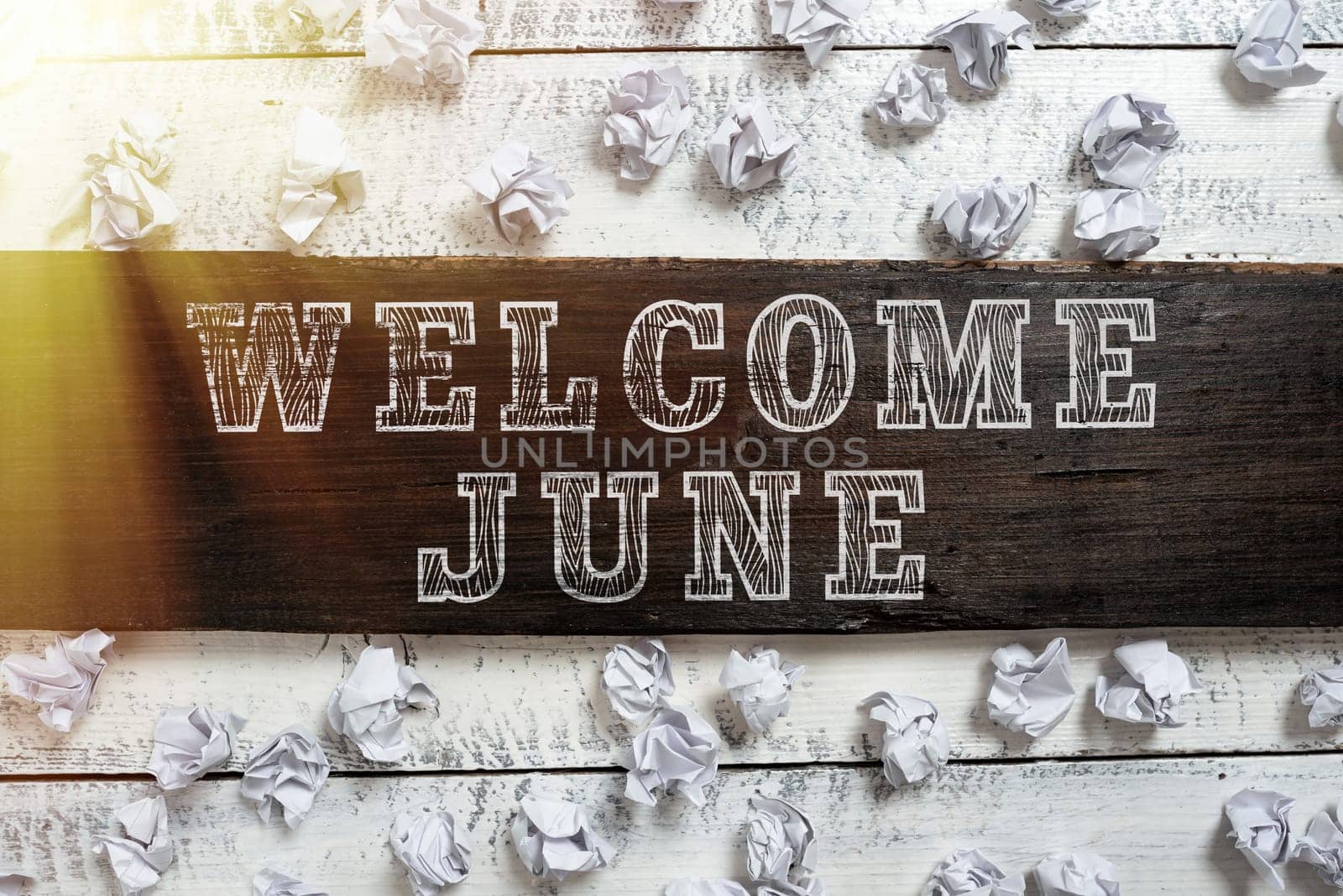Handwriting text Welcome June, Business concept Calendar Sixth Month Second Quarter Thirty days Greetings Important Ideas Written On Piece Of Wood With Paper Wraps Around On Floor.