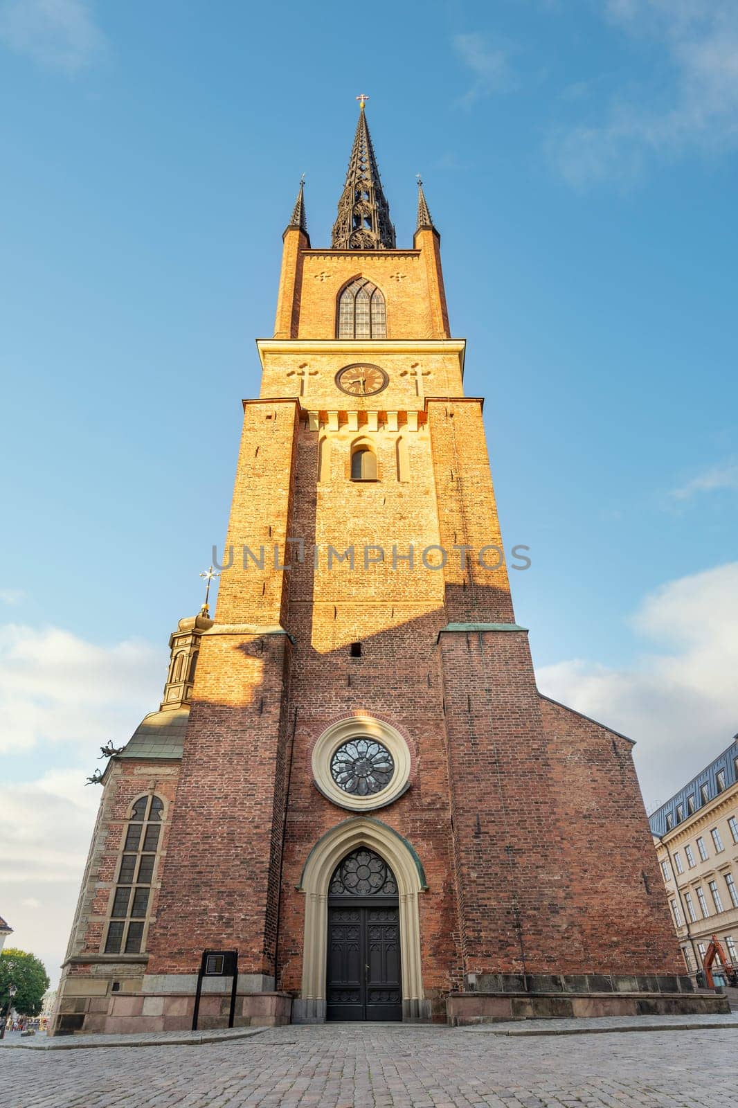 Tower of Riddarholmen Church, located in the island of Riddarholmshamnen, old city, Gamla stan. before sunset in a summer day, Stockholm, Sweden