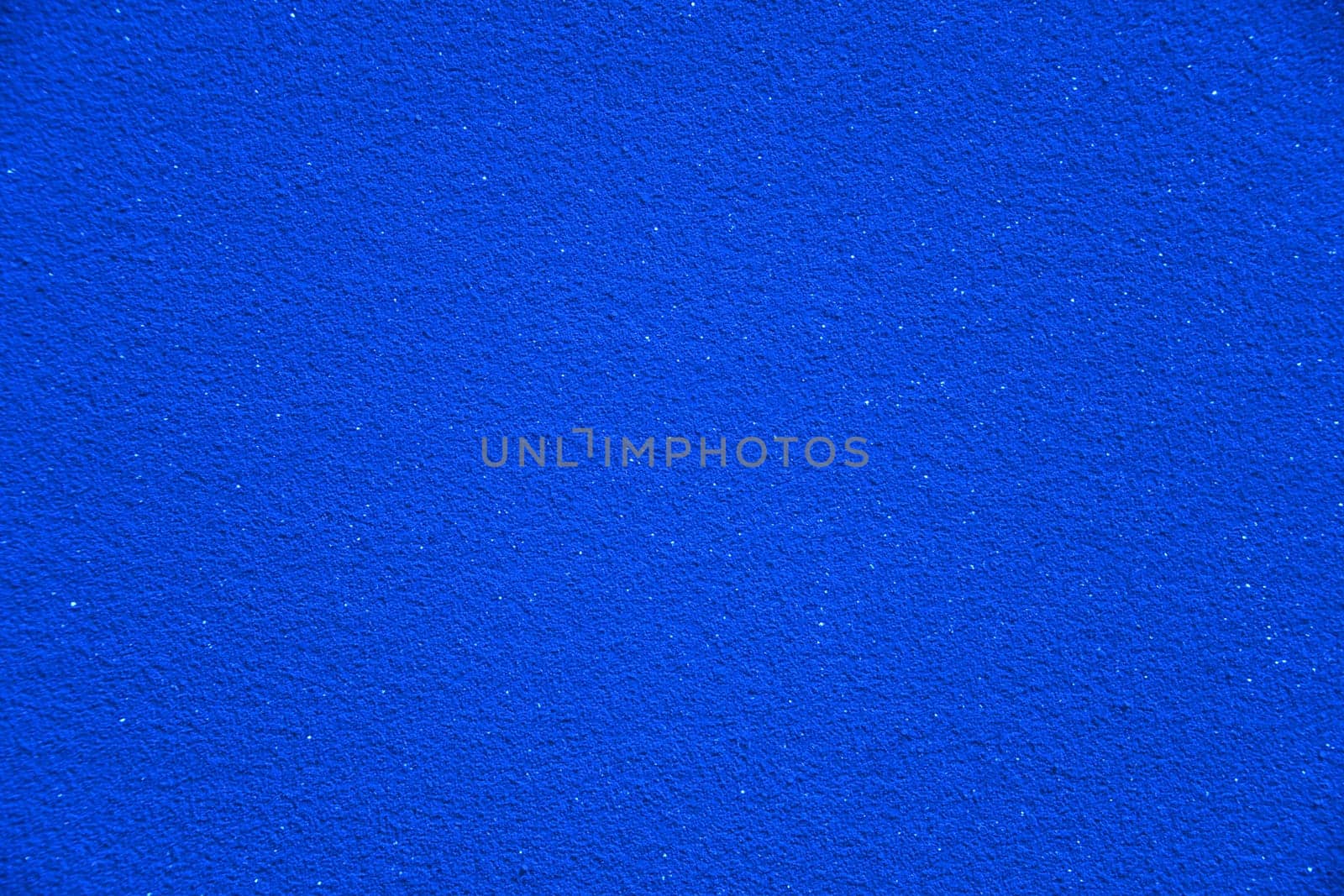 A very intense blue color with sparkling elements as a background. The deep blue is reminiscent of a sparkling and glittering starry sky.