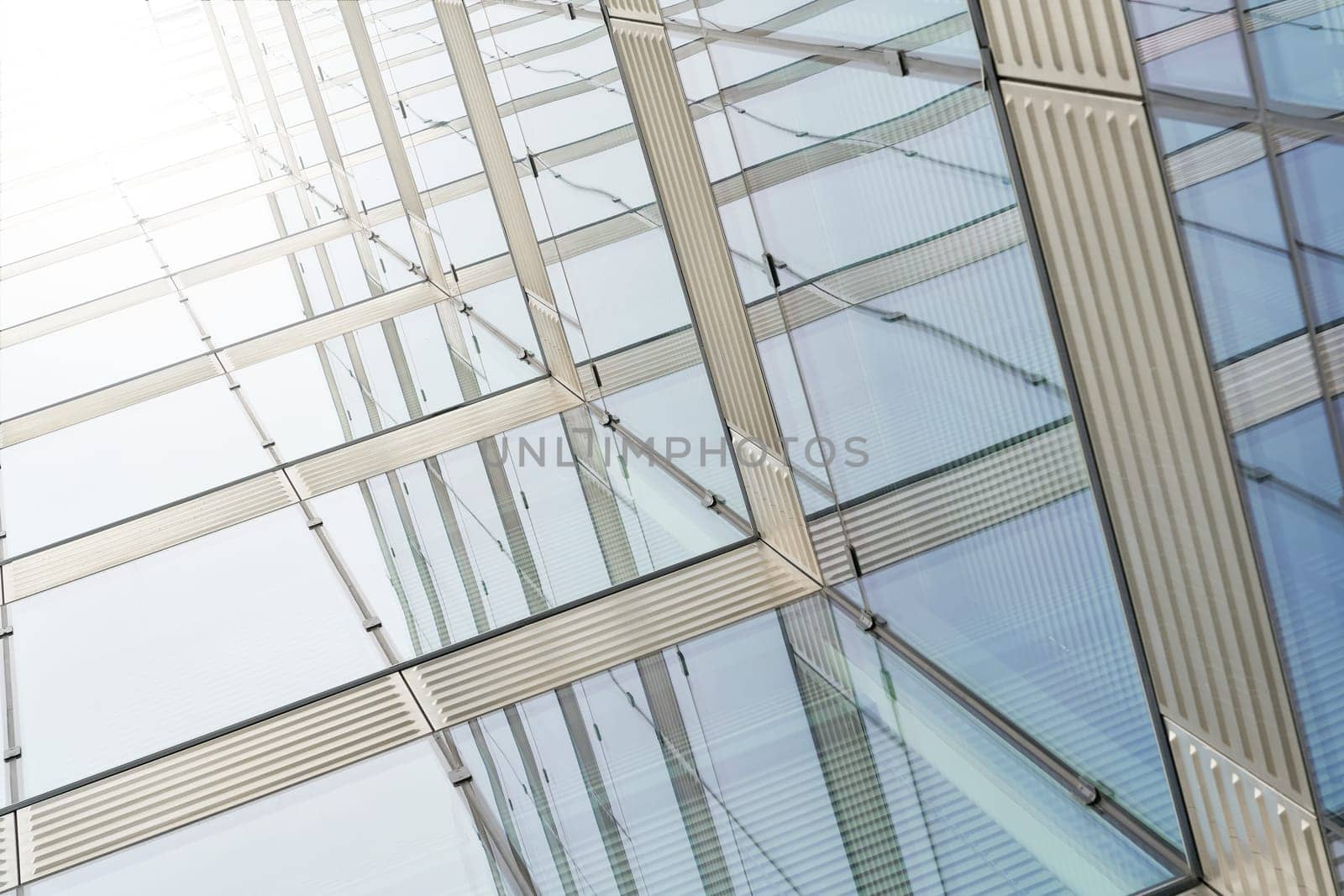 Glass facade of an office building with strong sunlight in the center of Berlin