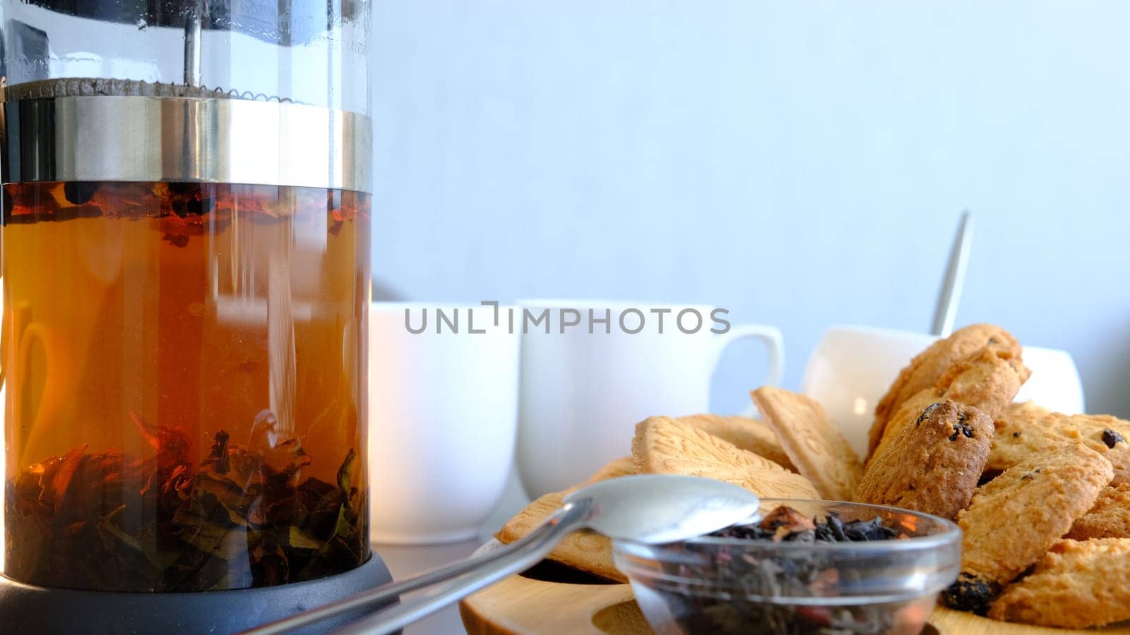 Jar with tea drink man hand filtering tea in glass
