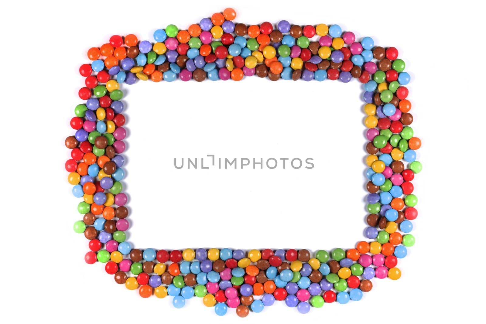 A Frame border of multi coloured halloween candy sweets on white