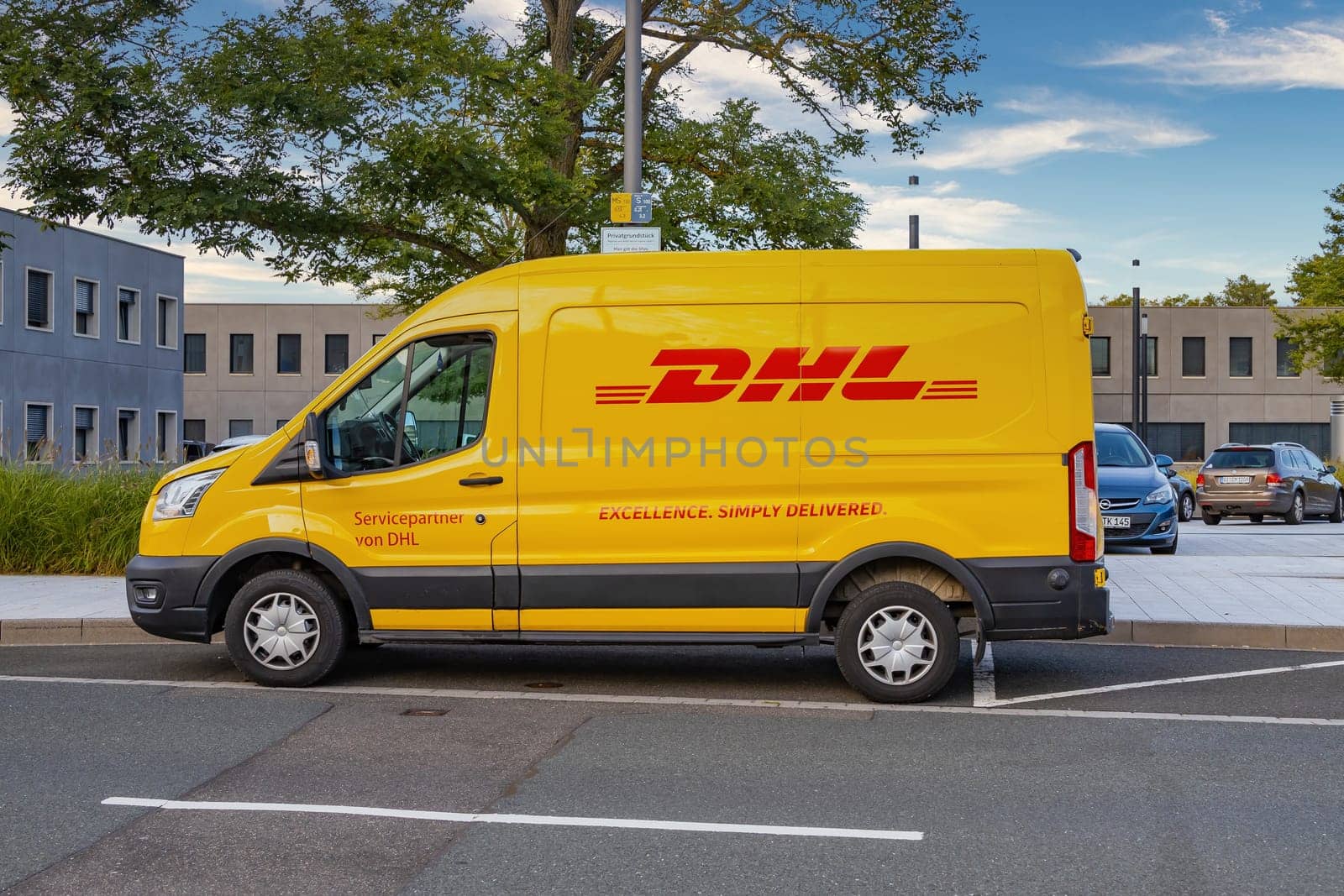 WETZLAR, GERMANY - 2021-10-01: DHL Logo on a yellow DHL Truck. DHL is owned by the German postal service Deutsche Post.