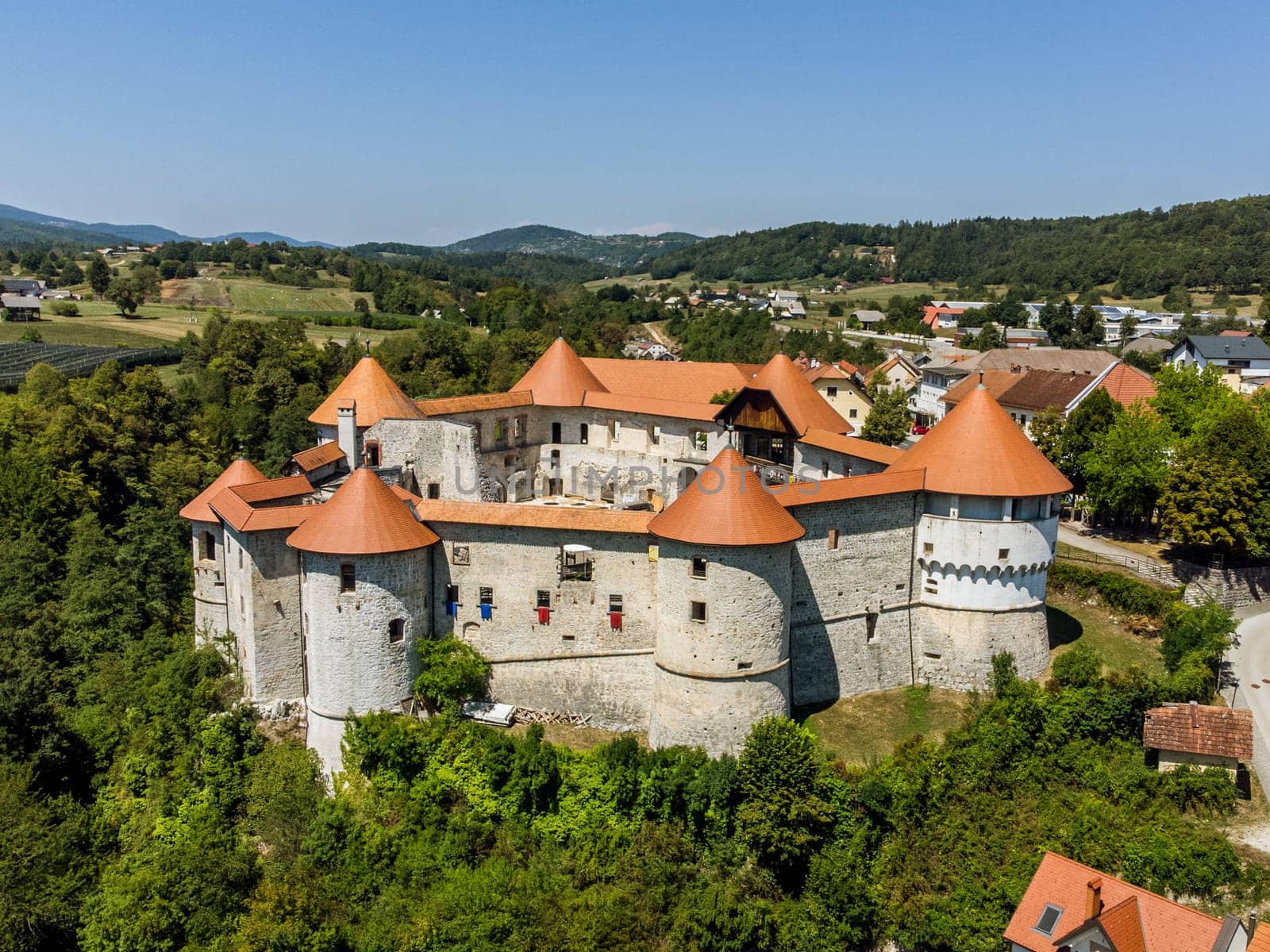 Aerial drone view of Medieval castle of Zuzemberk or Seisenburg or Sosenberch, positioned on terrace above the Krka River Canyon, Central Slovenia