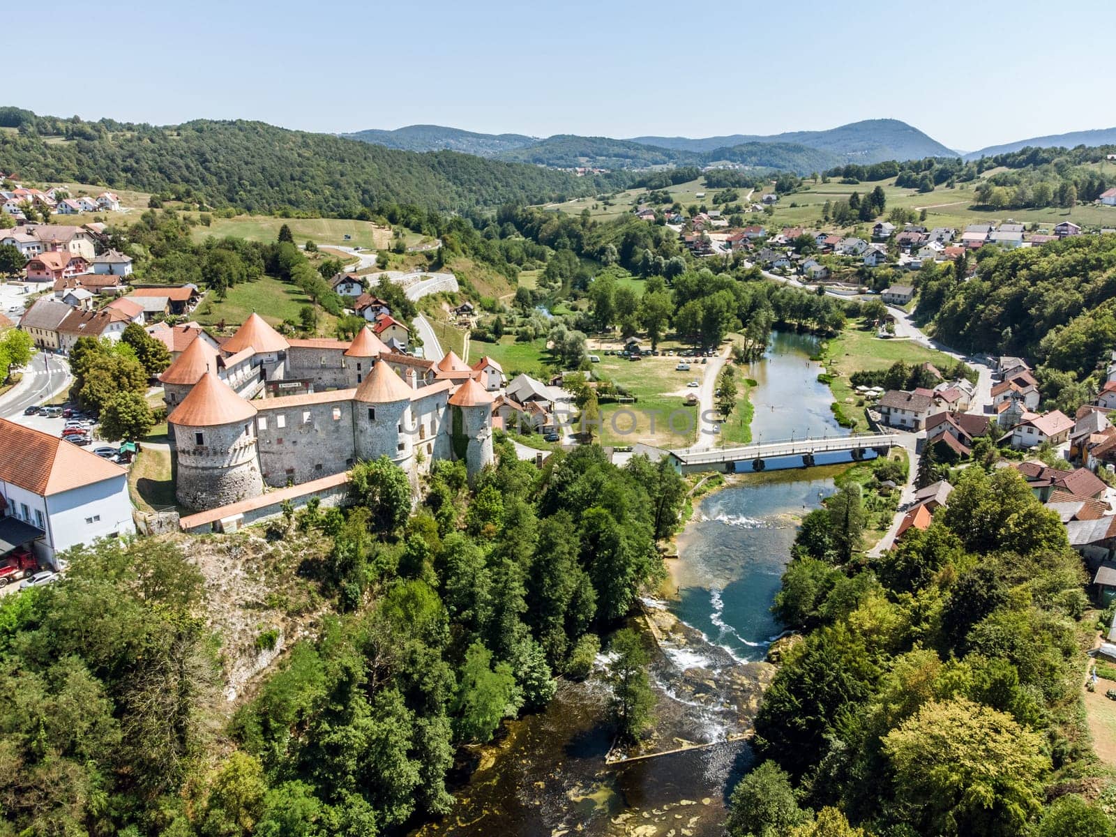 Aerial drone view of Medieval castle of Zuzemberk or Seisenburg or Sosenberch, positioned on terrace above the Krka River Canyon, Central Slovenia