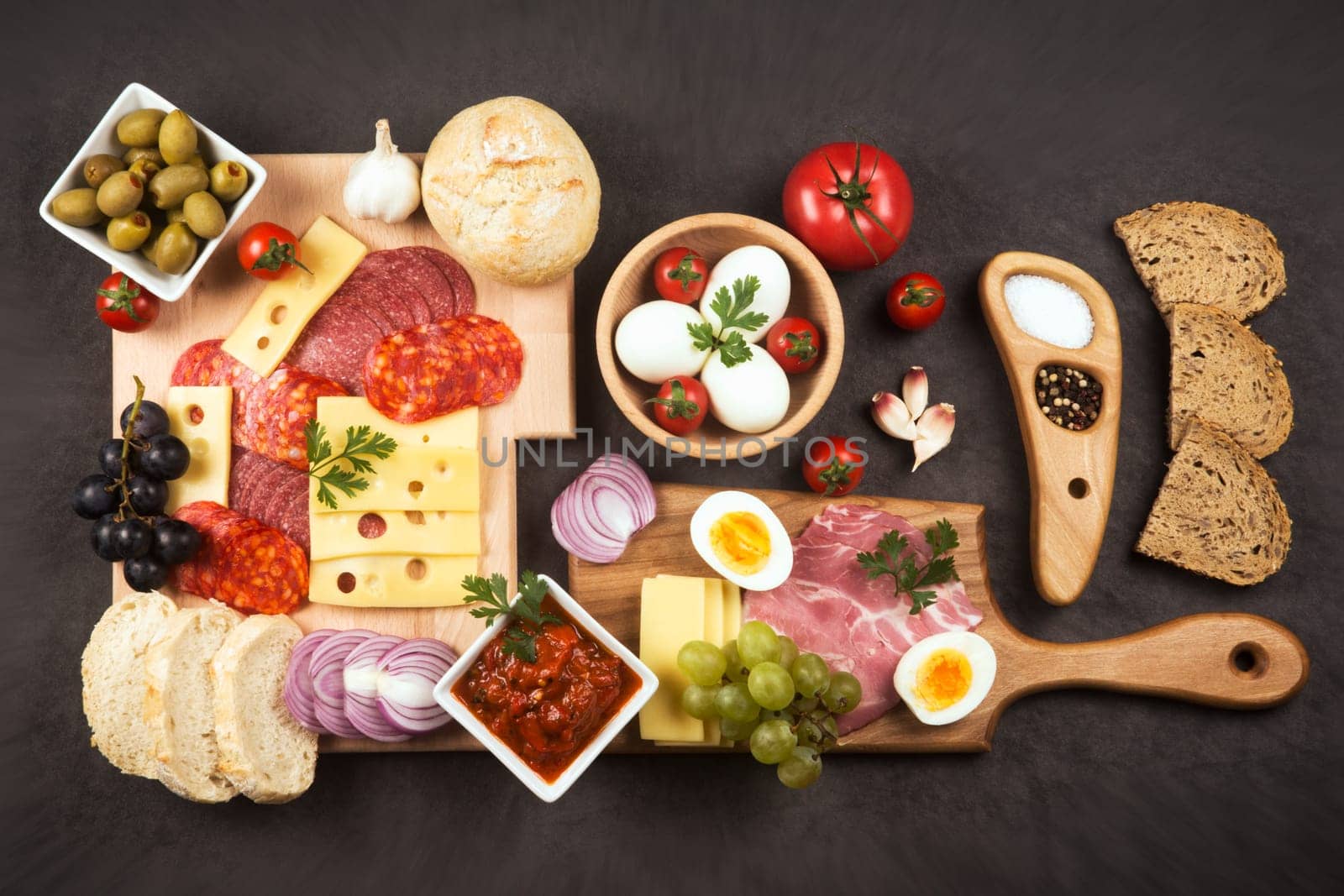 Gourmet appetizer platter or luxury breakfast tray is serving on dark gray background, food service and catering concept.