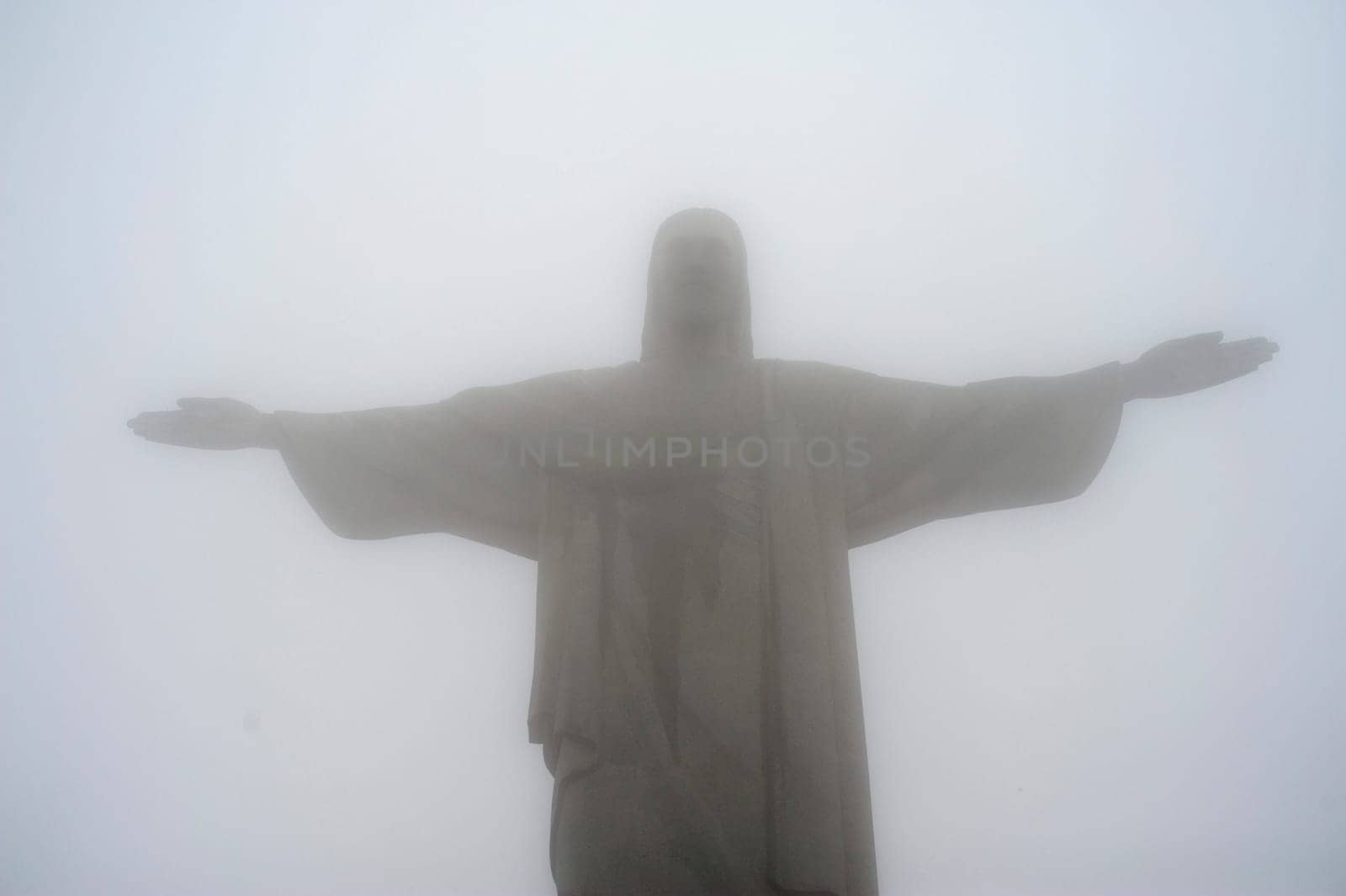 Rio de Janeiro, Brazil - September 14, 2019.  Redeemer Christ statue on Corcovado hill covered with fog..