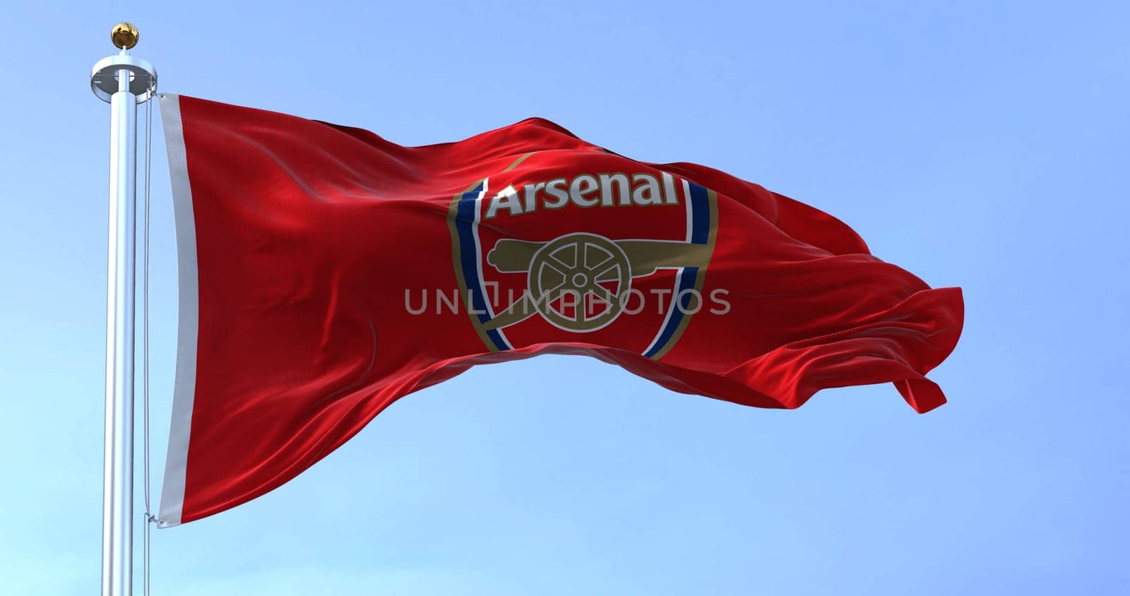 London, UK, May 2022: The flag of Arsenal Football Club waving in the wind on a clear day. Arsenal is a professional football club based in Islington, London, England