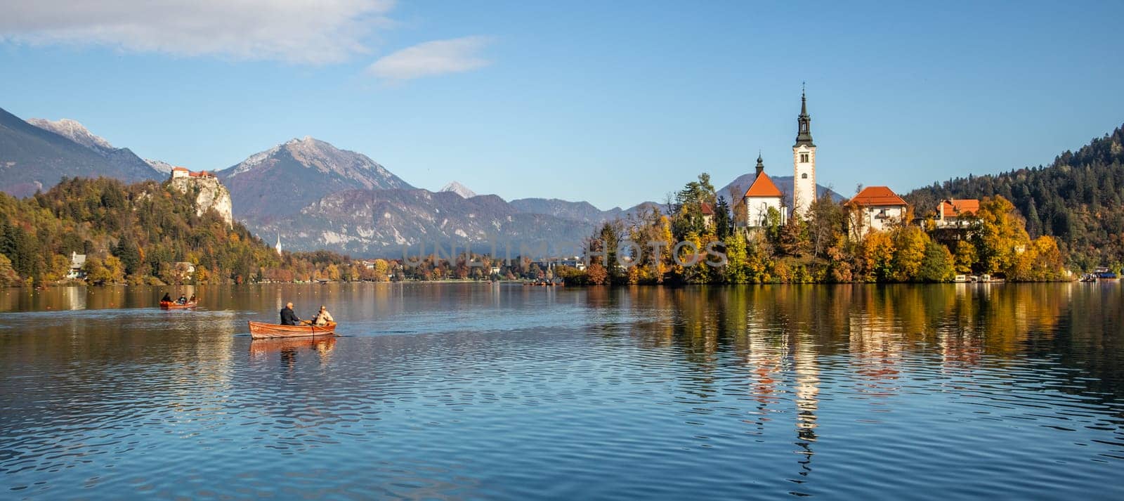 Panoramic view of Julian Alps, Lake Bled with St. Marys Church of the Assumption on the small island. Bled, Slovenia, Europe