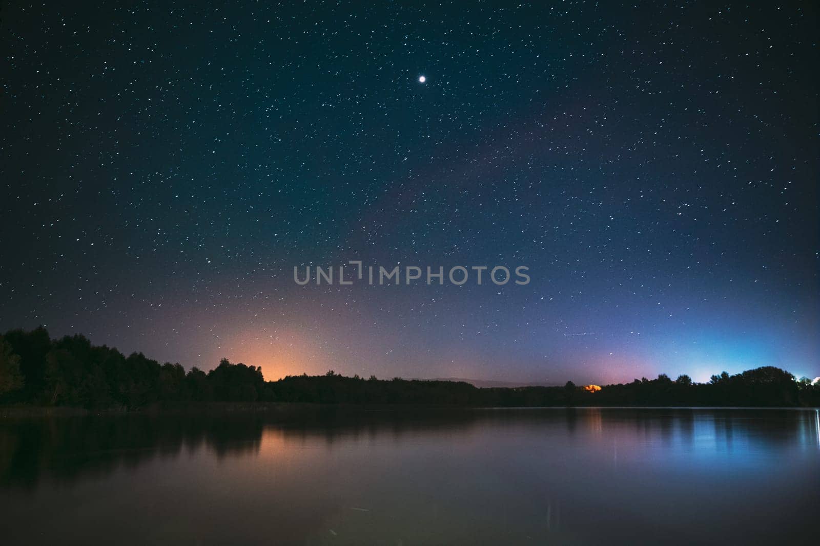 Village Novoye Lyadno, Lyepyel District, Vitebsk Province, Belarus. Real Colorful Night Stars Above Lepel Lake. Natural Starry Sky Background Backdrop Landscape.