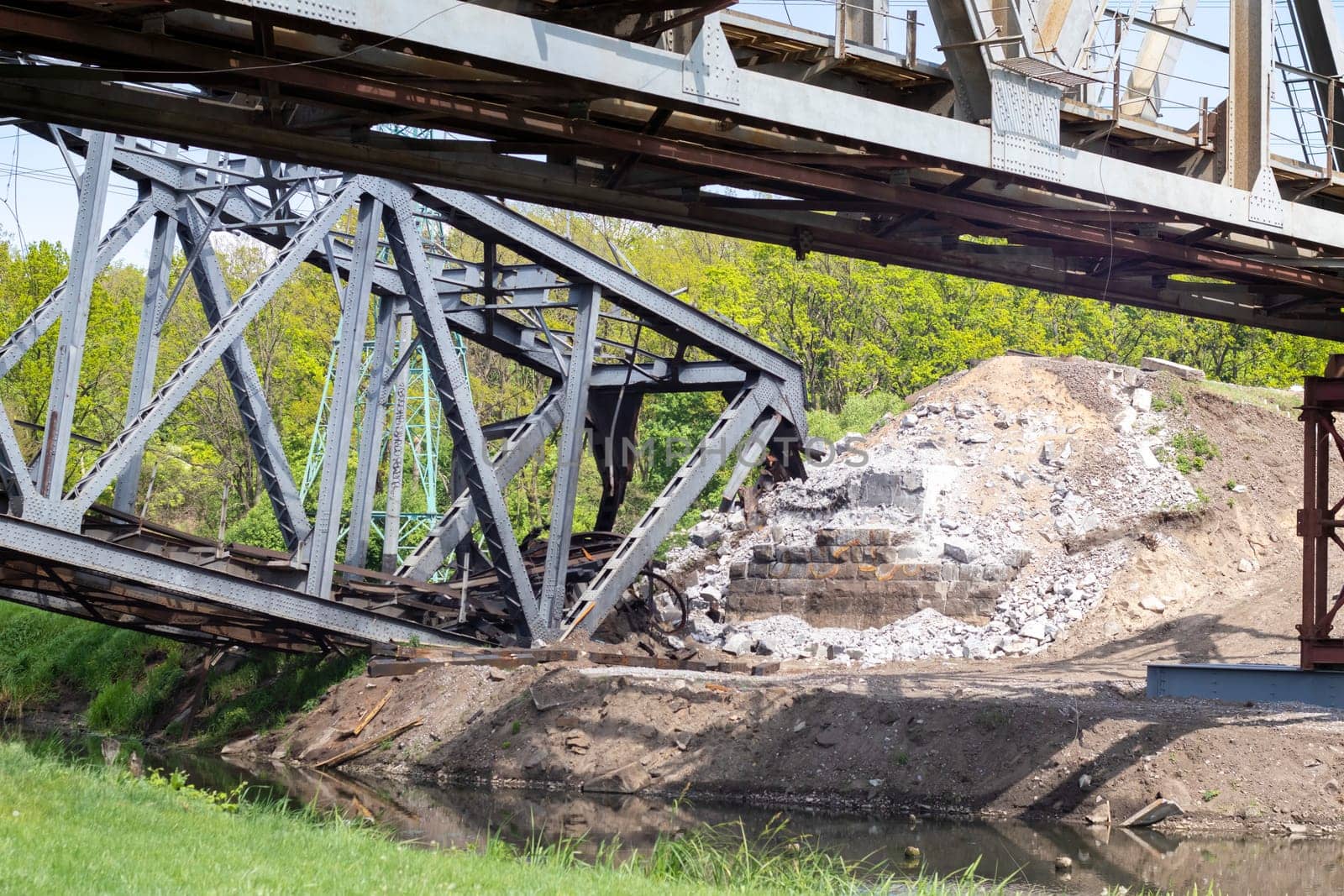 The blown up railway bridge over the Irpen River. War in Ukraine. Panorama. The city of Irpin in the Kyiv region. Ukraine, Irpin - May 24, 2022
