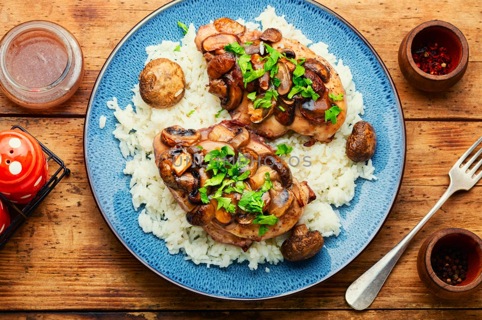 Baked chicken breast with marsala mushroom sauce and rice.