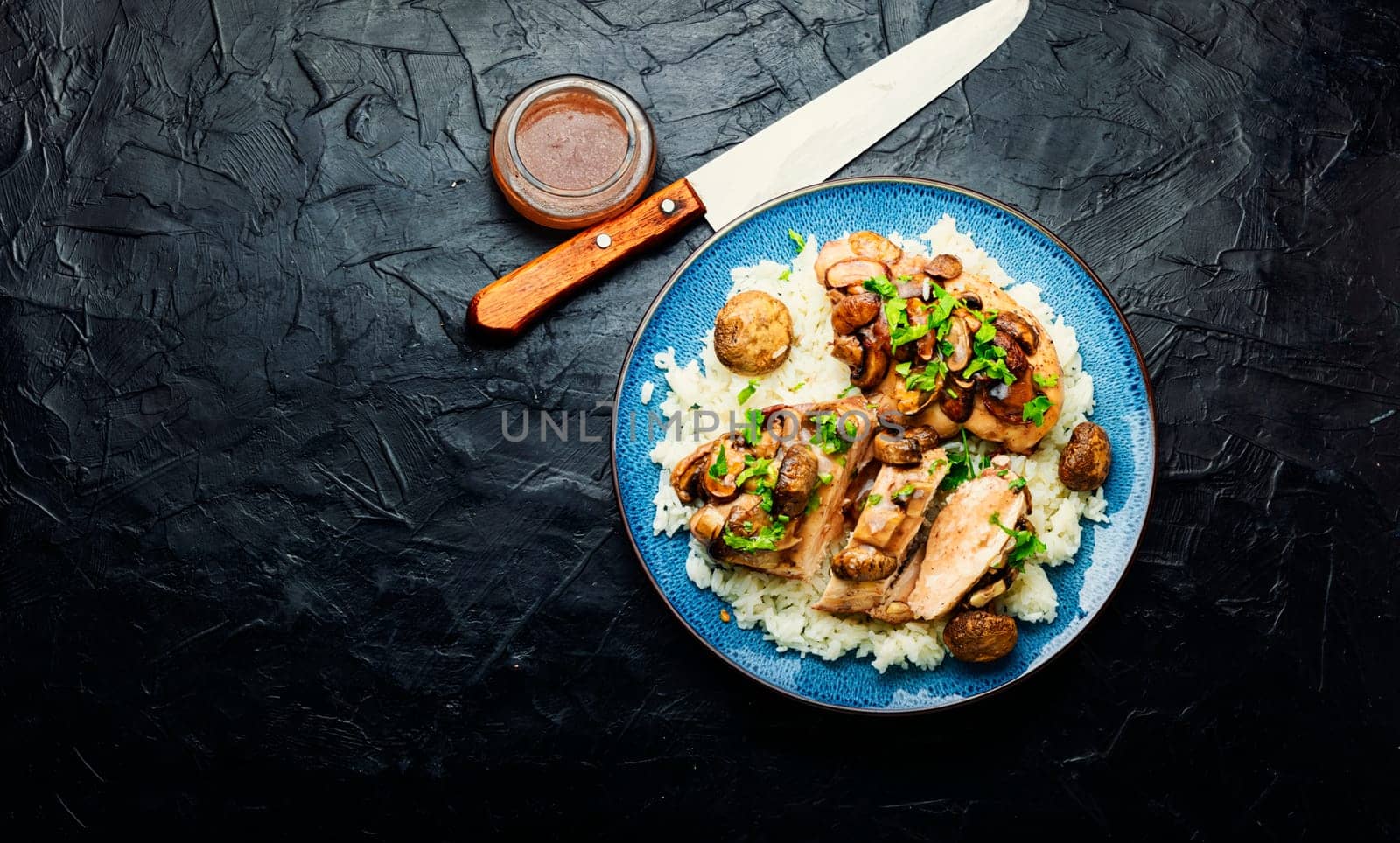 Baked chicken breast with marsala mushroom sauce and rice.