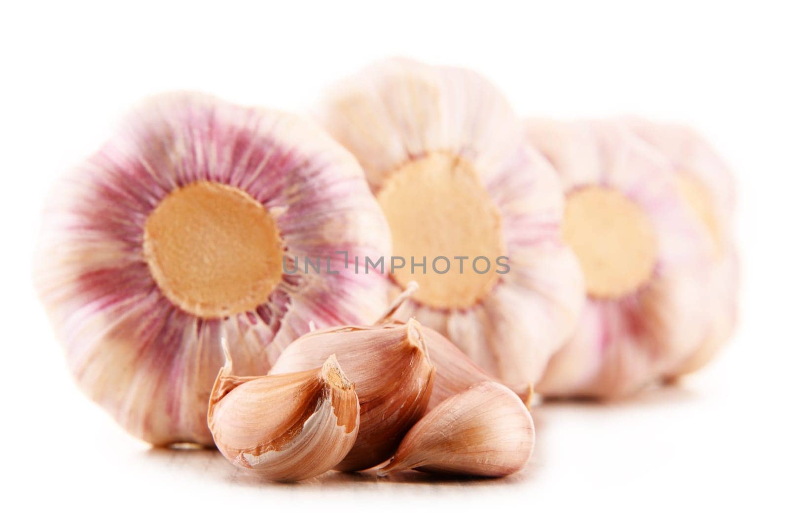 Composition with bulbs of garlic isolated on white background