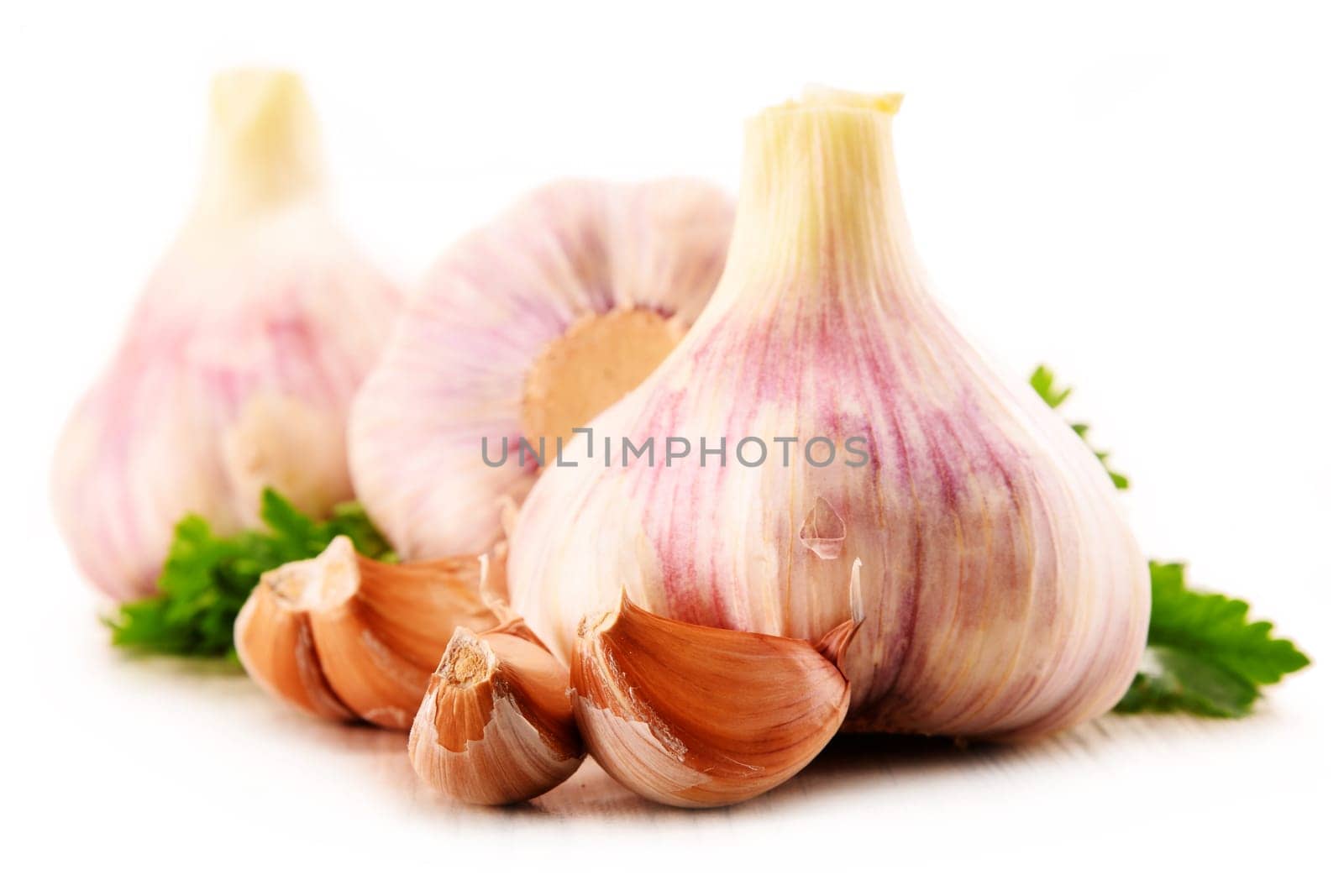 Composition with bulbs of garlic isolated on white background