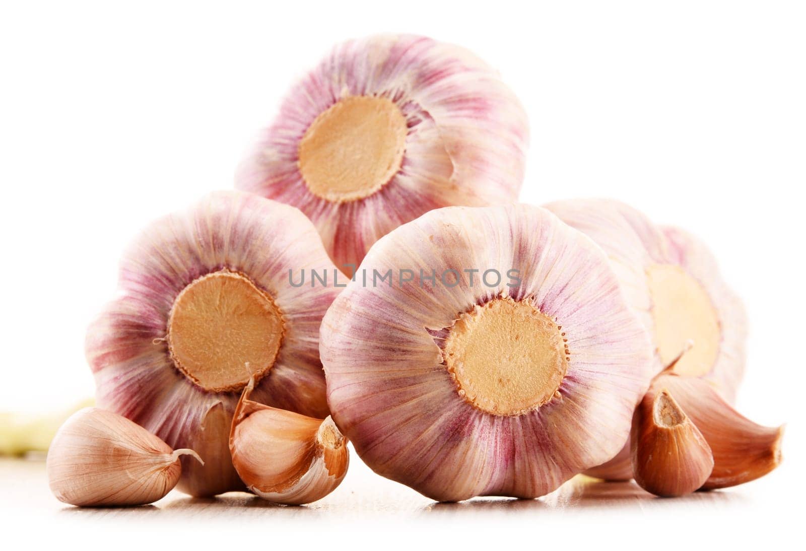 Composition with bulbs of garlic isolated on white background