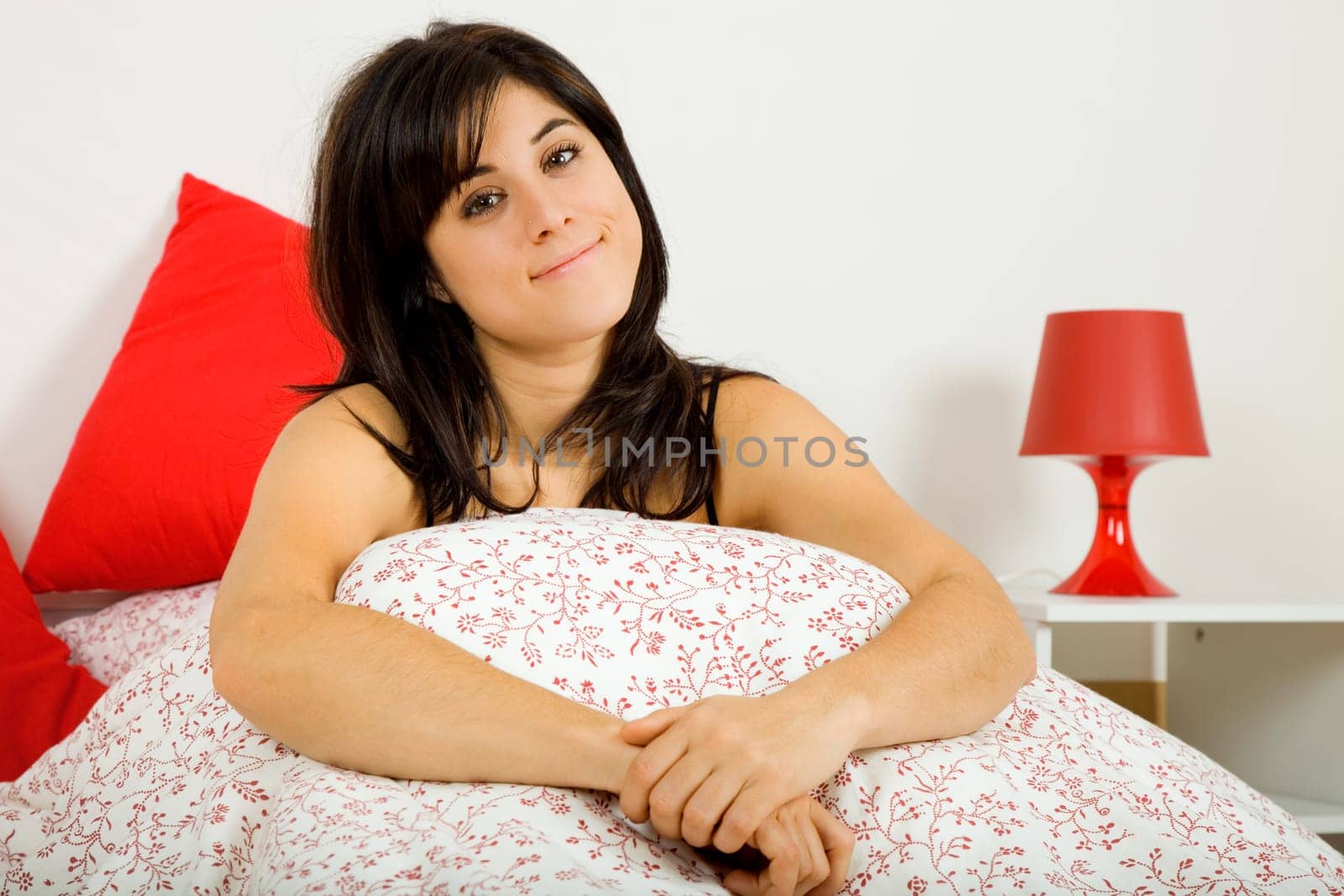an young beautiful sensual woman in bed