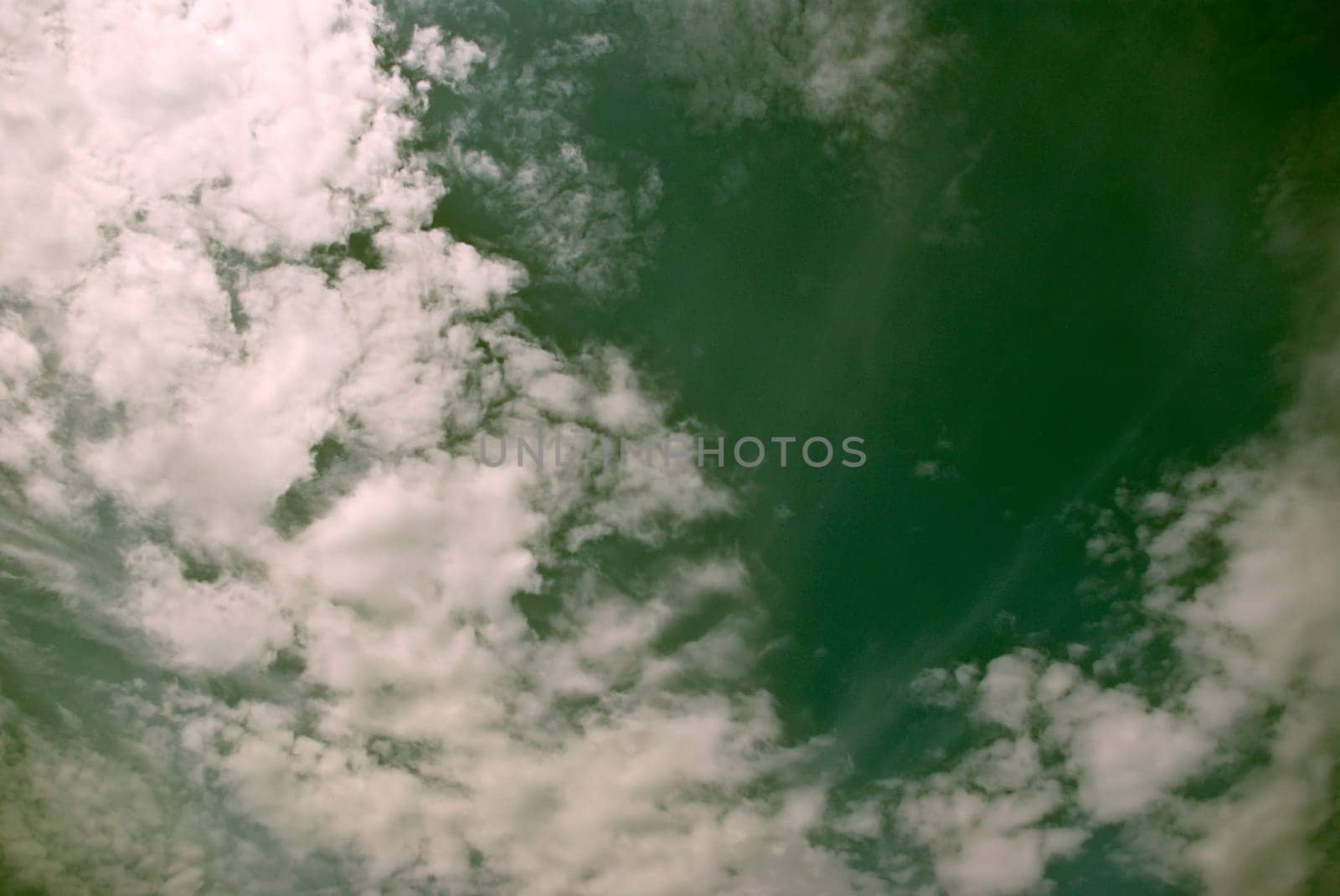 The soft white clouds against blue sky